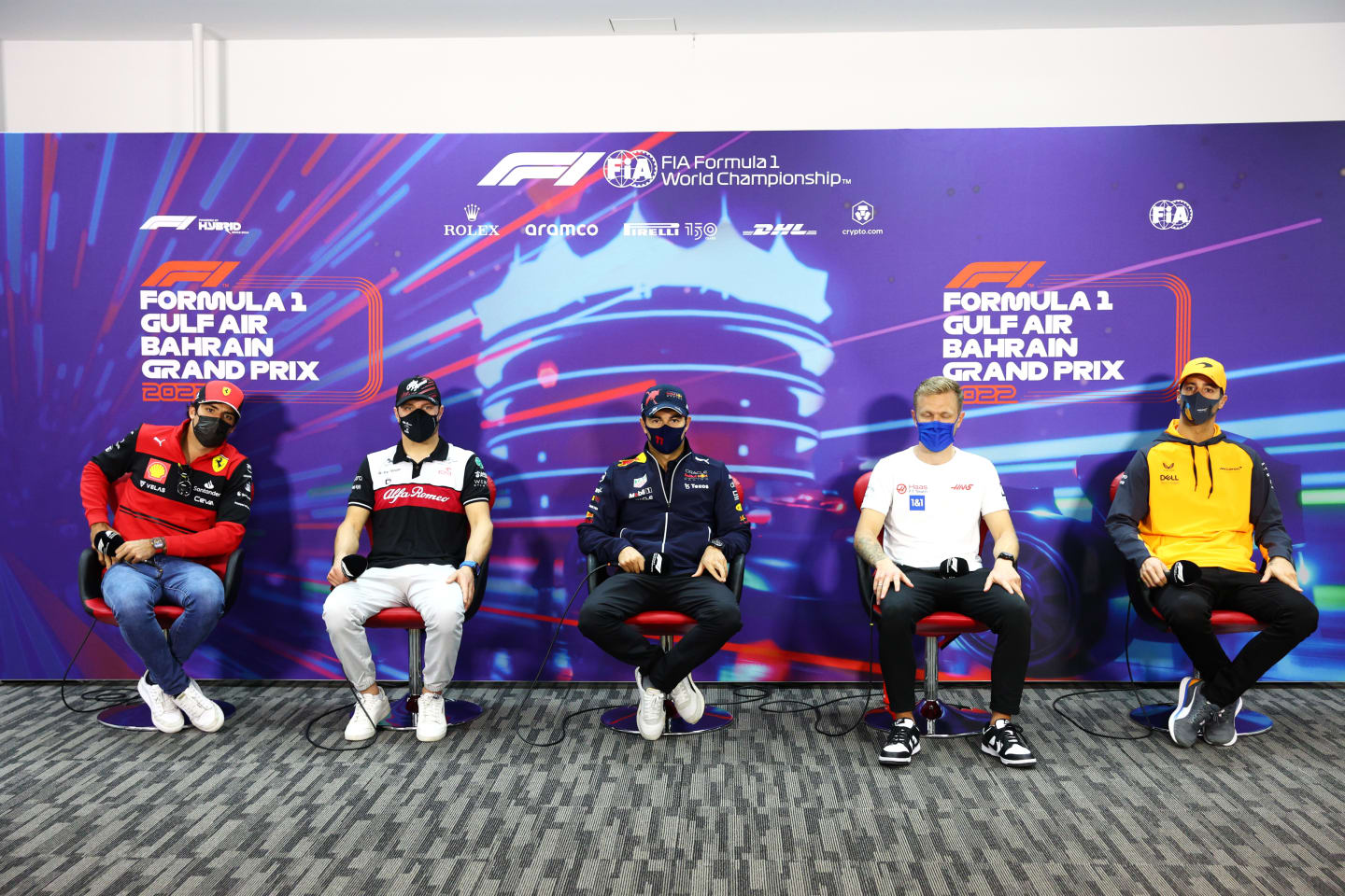 BAHRAIN, BAHRAIN - MARCH 18: (L-R) Carlos Sainz of Spain and Ferrari, Valtteri Bottas of Finland and Alfa Romeo F1, Sergio Perez of Mexico and Oracle Red Bull Racing, Kevin Magnussen of Denmark and Haas F1 and Daniel Ricciardo of Australia and McLaren attend the Drivers Press Conference before practice ahead of the F1 Grand Prix of Bahrain at Bahrain International Circuit on March 18, 2022 in Bahrain, Bahrain. (Photo by Clive Rose/Getty Images)