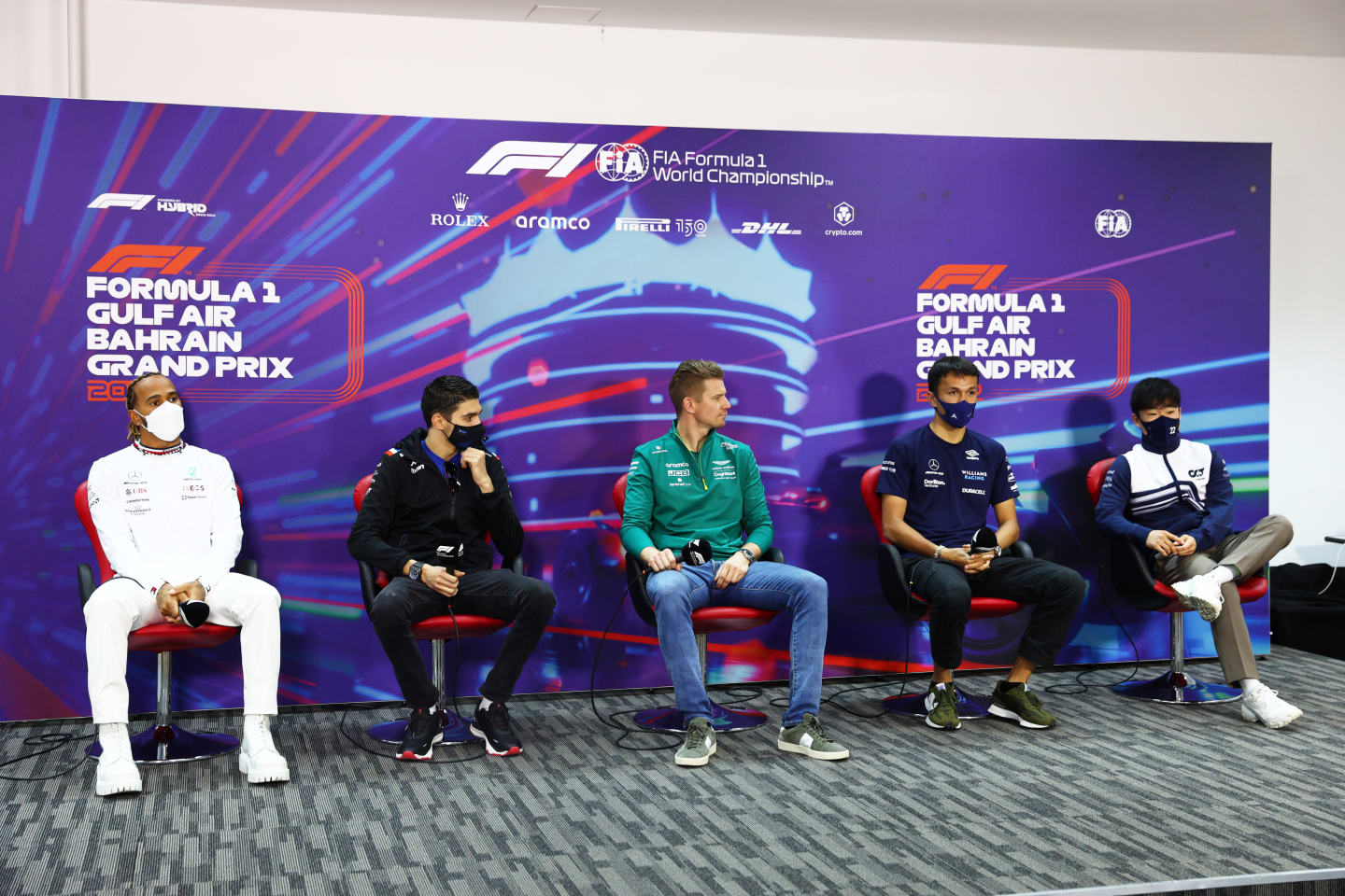 BAHRAIN, BAHRAIN - MARCH 18: (L-R) Lewis Hamilton of Great Britain and Mercedes, Esteban Ocon of France and Alpine F1, Nico Hulkenberg of Germany driving the (27) Aston Martin AMR22 Mercedes[, Alexander Albon of Thailand and Williams and Yuki Tsunoda of Japan and Scuderia AlphaTauri attend the Drivers Press Conference before practice ahead of the F1 Grand Prix of Bahrain at Bahrain International Circuit on March 18, 2022 in Bahrain, Bahrain. (Photo by Lars Baron/Getty Images)