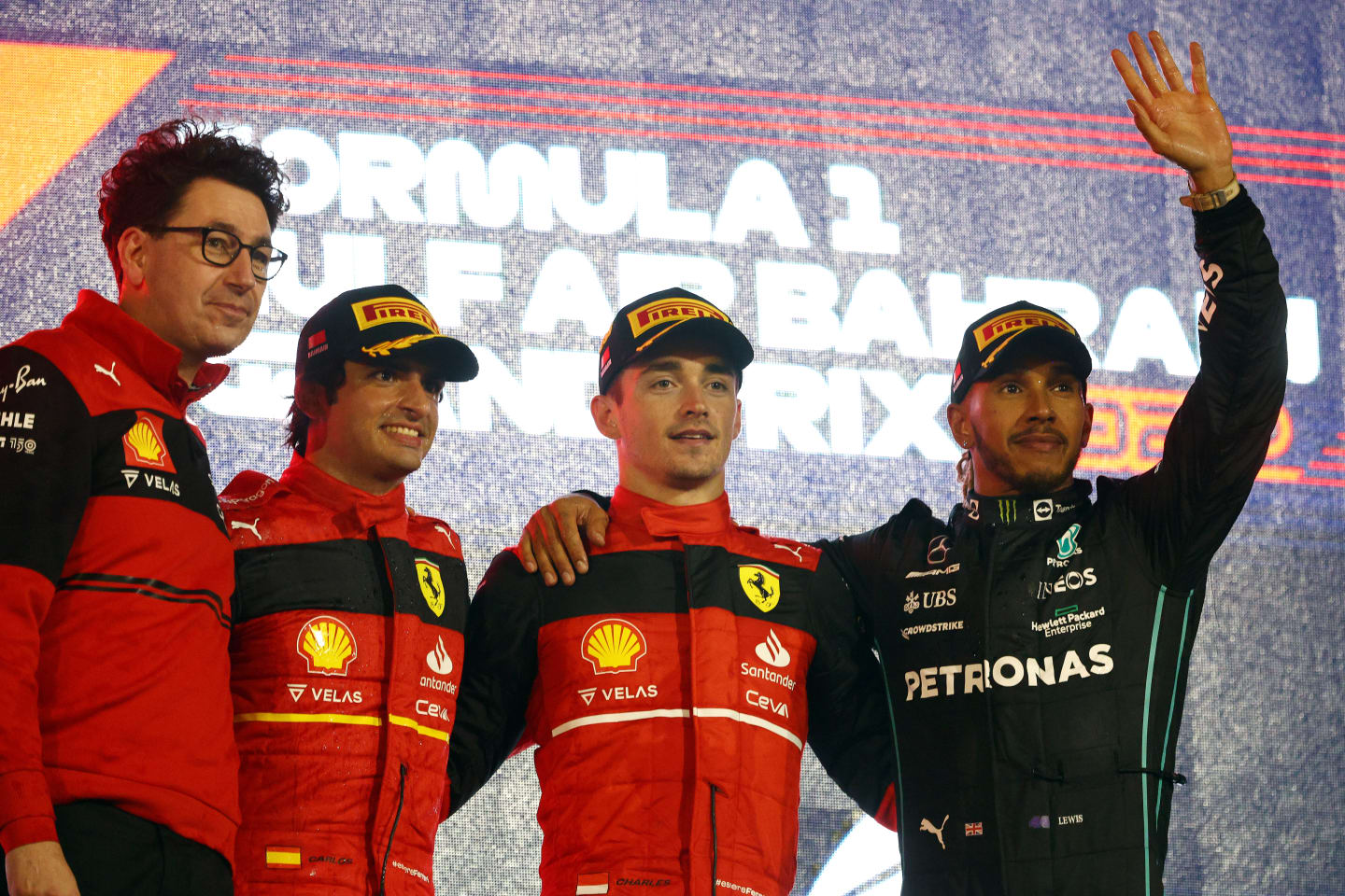 BAHRAIN, BAHRAIN - MARCH 20: Race winner Charles Leclerc of Monaco and Ferrari (second from right), Second placed Carlos Sainz of Spain and Ferrari (second from left) Third placed Lewis Hamilton of Great Britain and Mercedes (R) and Scuderia Ferrari Team Principal Mattia Binotto (L) celebrate on the podium during the F1 Grand Prix of Bahrain at Bahrain International Circuit on March 20, 2022 in Bahrain, Bahrain. (Photo by Clive Rose - Formula 1/Formula 1 via Getty Images)