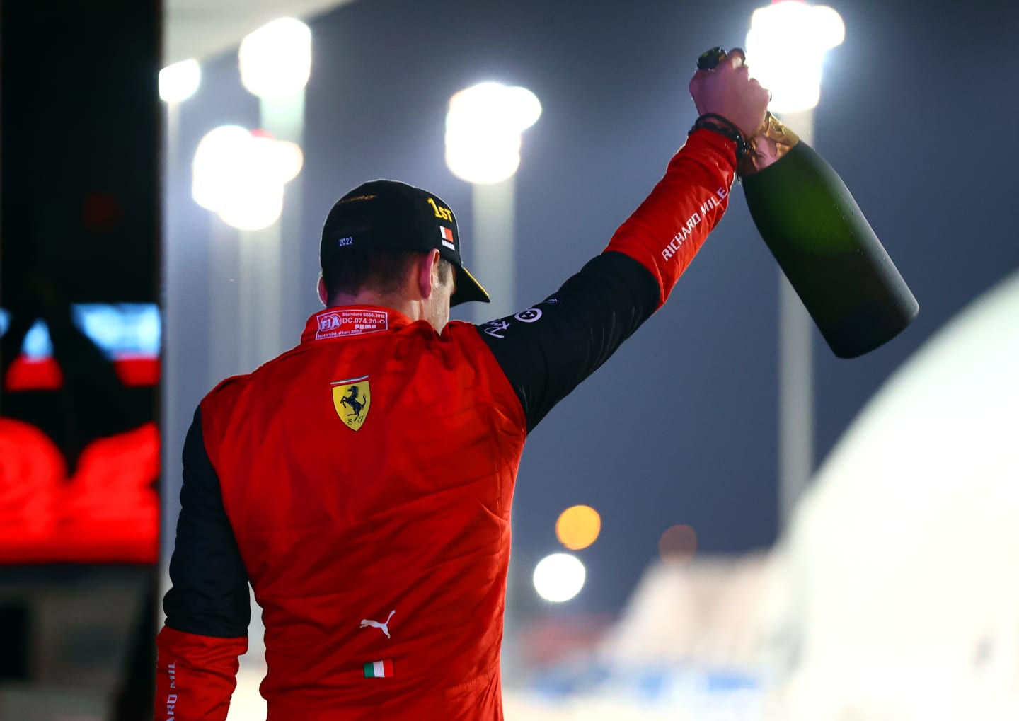 BAHRAIN, BAHRAIN - MARCH 20: Race winner Charles Leclerc of Monaco and Ferrari celebrates on the podium during the F1 Grand Prix of Bahrain at Bahrain International Circuit on March 20, 2022 in Bahrain, Bahrain. (Photo by Dan Istitene - Formula 1/Formula 1 via Getty Images)