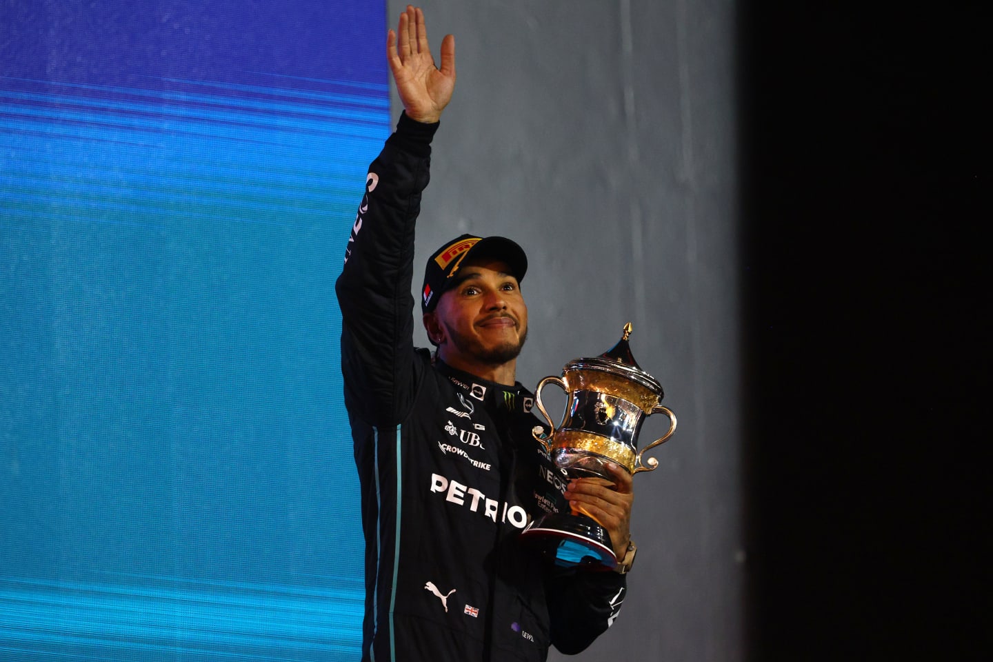 BAHRAIN, BAHRAIN - MARCH 20: Third placed Lewis Hamilton of Great Britain and Mercedes celebrates on the podium during the F1 Grand Prix of Bahrain at Bahrain International Circuit on March 20, 2022 in Bahrain, Bahrain. (Photo by Clive Rose - Formula 1/Formula 1 via Getty Images)
