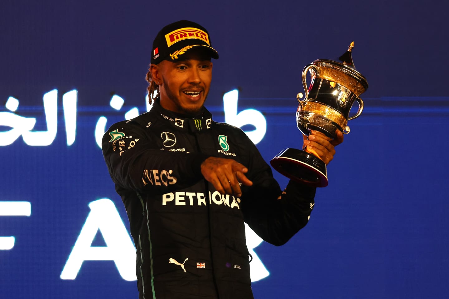 BAHRAIN, BAHRAIN - MARCH 20: Third placed Lewis Hamilton of Great Britain and Mercedes celebrates on the podium during the F1 Grand Prix of Bahrain at Bahrain International Circuit on March 20, 2022 in Bahrain, Bahrain. (Photo by Lars Baron/Getty Images)