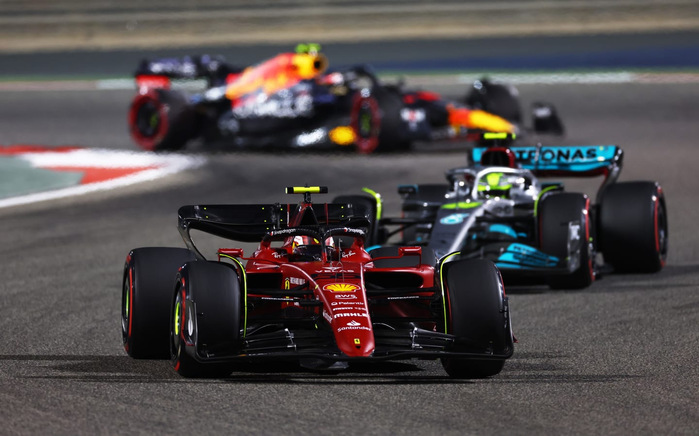 BAHRAIN, BAHRAIN - MARCH 20: Carlos Sainz of Spain driving (55) the Ferrari F1-75 leads Lewis