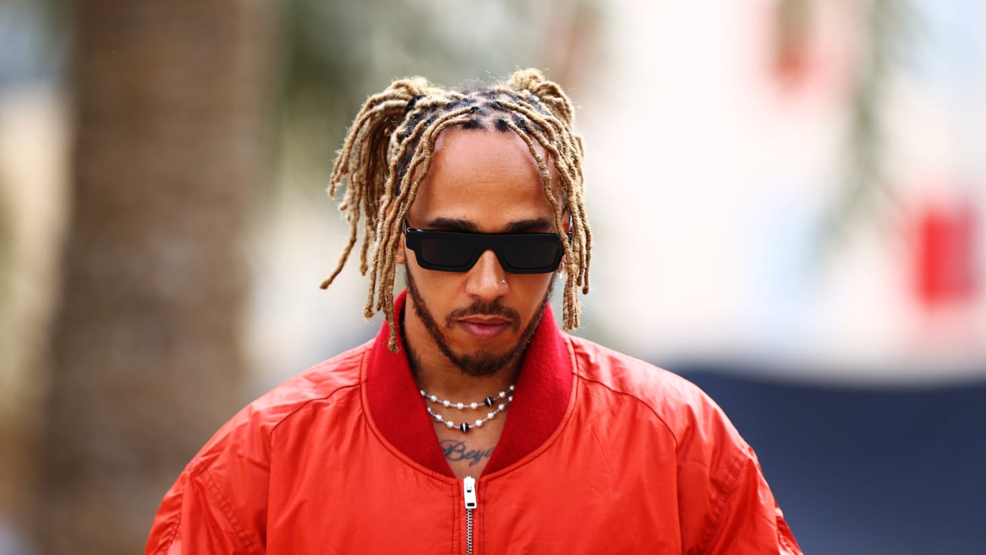 BAHRAIN, BAHRAIN - MARCH 17: Lewis Hamilton of Great Britain and Mercedes walks in the Paddock