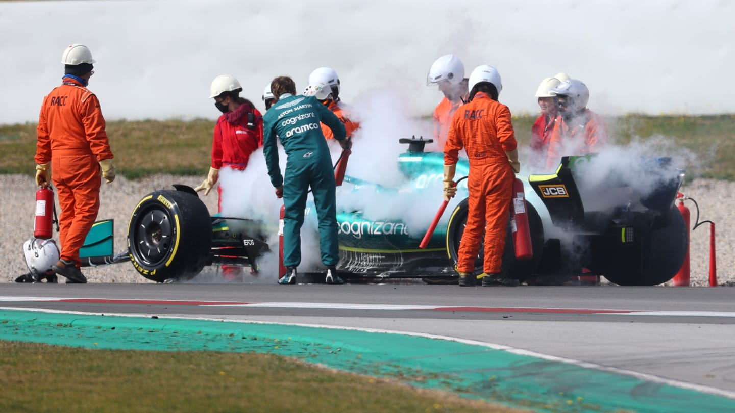 BARCELONA, SPAIN - FEBRUARY 25: Sebastian Vettel of Germany and Aston Martin F1 Team uses a fire extinguisher on his car after he stopped on track during Day Three of F1 Testing at Circuit de Barcelona-Catalunya on February 25, 2022 in Barcelona, Spain. (Photo by Dan Istitene - Formula 1/Formula 1 via Getty Images)