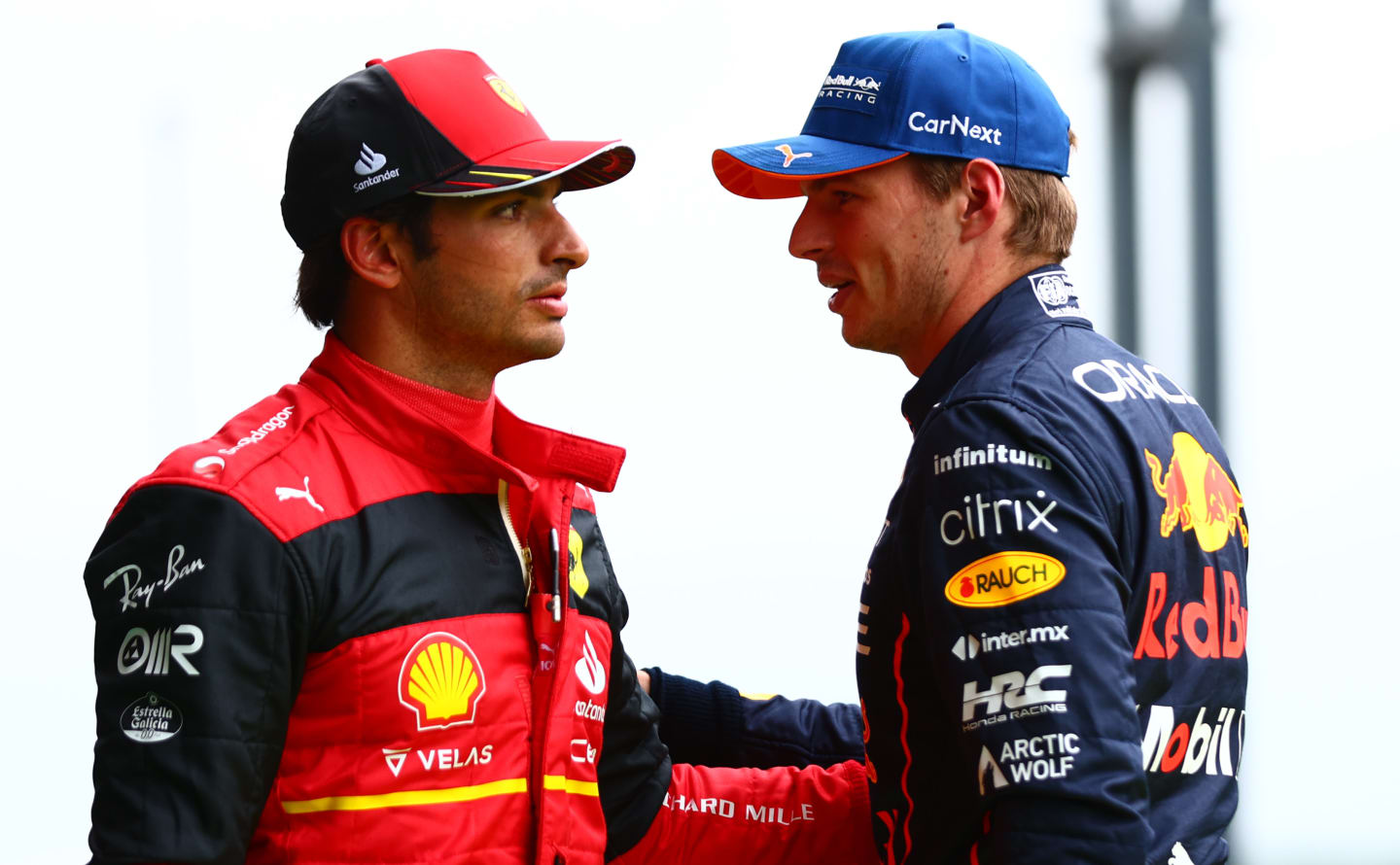 SPA, BELGIUM - AUGUST 27: Pole position qualifier Max Verstappen of the Netherlands and Oracle Red Bull Racing and Second placed qualifier Carlos Sainz of Spain and Ferrari talk in parc ferme during qualifying ahead of the F1 Grand Prix of Belgium at Circuit de Spa-Francorchamps on August 27, 2022 in Spa, Belgium. (Photo by Dan Istitene - Formula 1/Formula 1 via Getty Images)