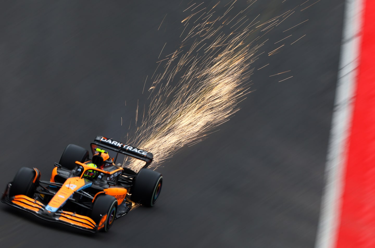 SPA, BELGIUM - AUGUST 27: Sparks fly behind Lando Norris of Great Britain driving the (4) McLaren