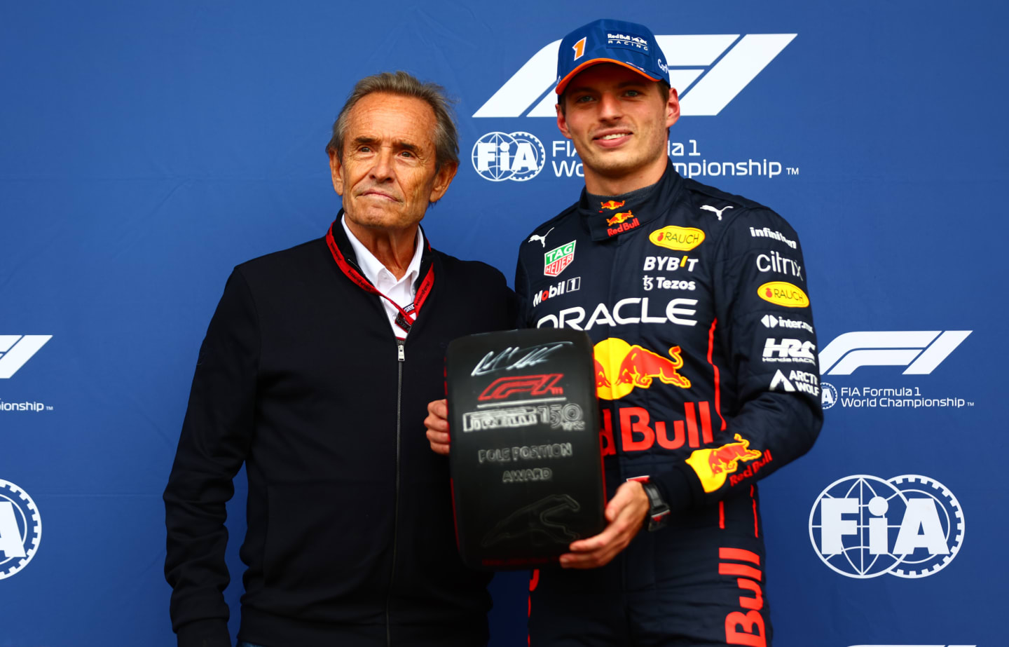 SPA, BELGIUM - AUGUST 27: Pole position qualifier Max Verstappen of the Netherlands and Oracle Red Bull Racing is presented with the Pirelli Pole Position trophy by Jacky Ickx in parc ferme during qualifying ahead of the F1 Grand Prix of Belgium at Circuit de Spa-Francorchamps on August 27, 2022 in Spa, Belgium. (Photo by Dan Istitene - Formula 1/Formula 1 via Getty Images)