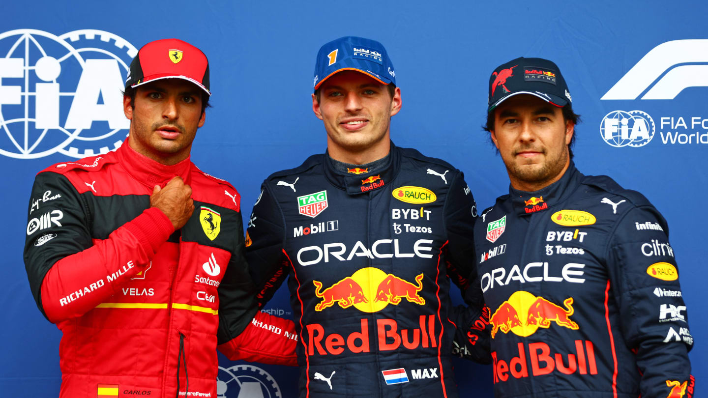 SPA, BELGIUM - AUGUST 27: Pole position qualifier Max Verstappen of the Netherlands and Oracle Red Bull Racing (C), Second placed qualifier Carlos Sainz of Spain and Ferrari (L) and Third placed qualifier Sergio Perez of Mexico and Oracle Red Bull Racing (R) pose for a photo in parc ferme during qualifying ahead of the F1 Grand Prix of Belgium at Circuit de Spa-Francorchamps on August 27, 2022 in Spa, Belgium. (Photo by Dan Istitene - Formula 1/Formula 1 via Getty Images)
