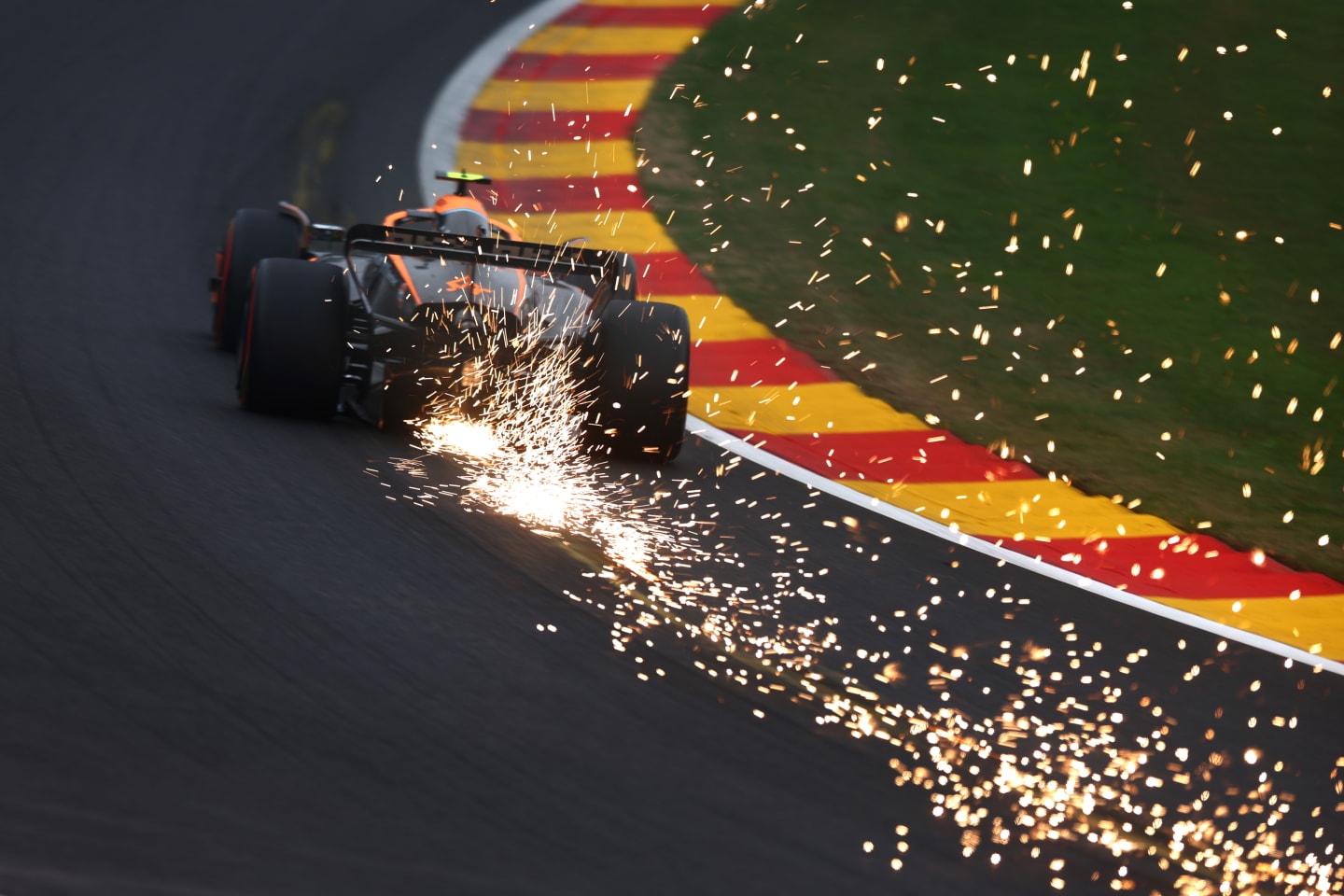 SPA, BELGIUM - AUGUST 27: Sparks fly behind Lando Norris of Great Britain driving the (4) McLaren