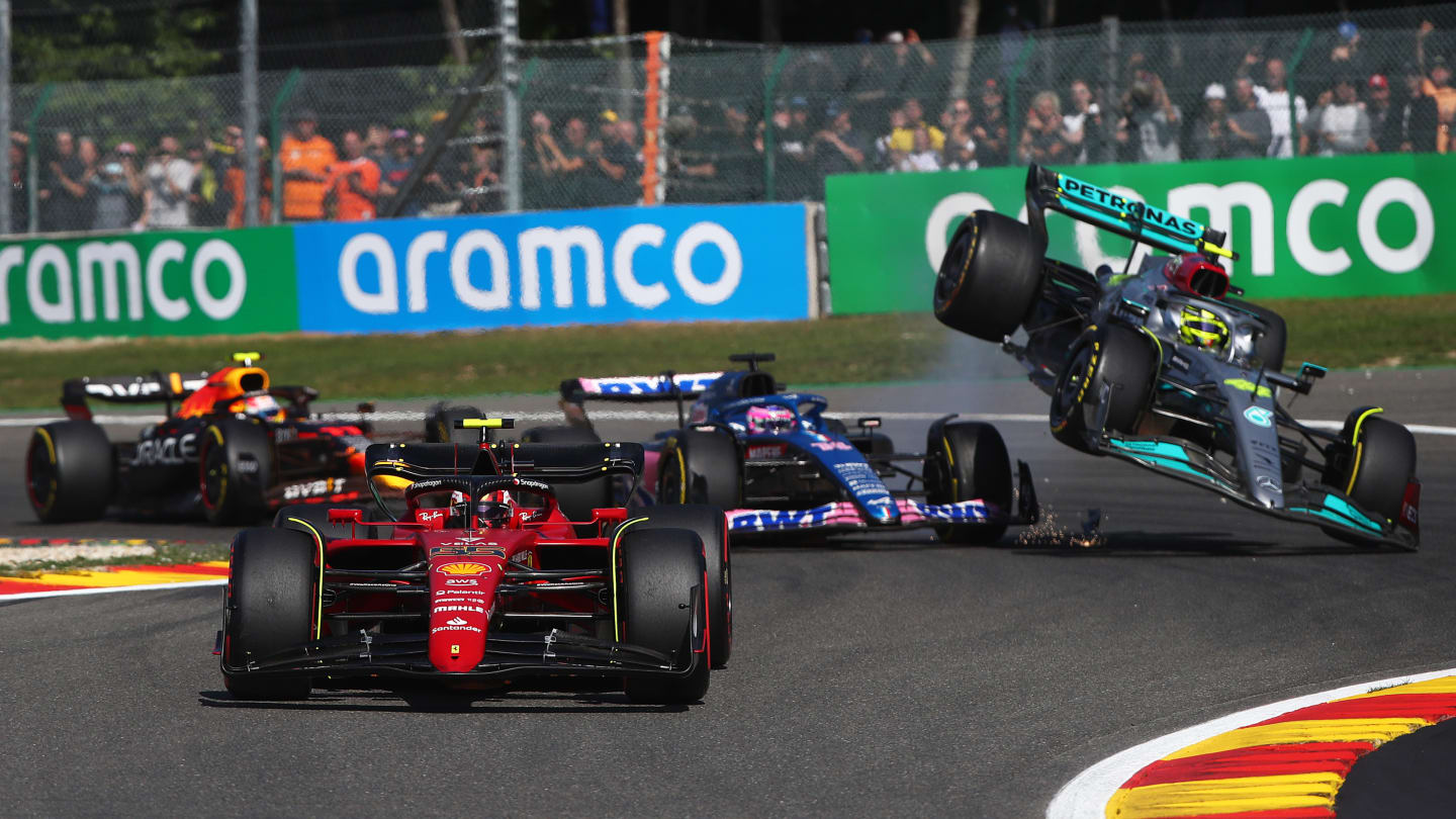 SPA, BELGIUM - AUGUST 28: Carlos Sainz of Spain driving (55) the Ferrari F1-75 leads the field as Fernando Alonso of Spain driving the (14) Alpine F1 A522 Renault and Lewis Hamilton of Great Britain driving the (44) Mercedes AMG Petronas F1 Team W13 crash during the F1 Grand Prix of Belgium at Circuit de Spa-Francorchamps on August 28, 2022 in Spa, Belgium. (Photo by Joe Portlock - Formula 1/Formula 1 via Getty Images)