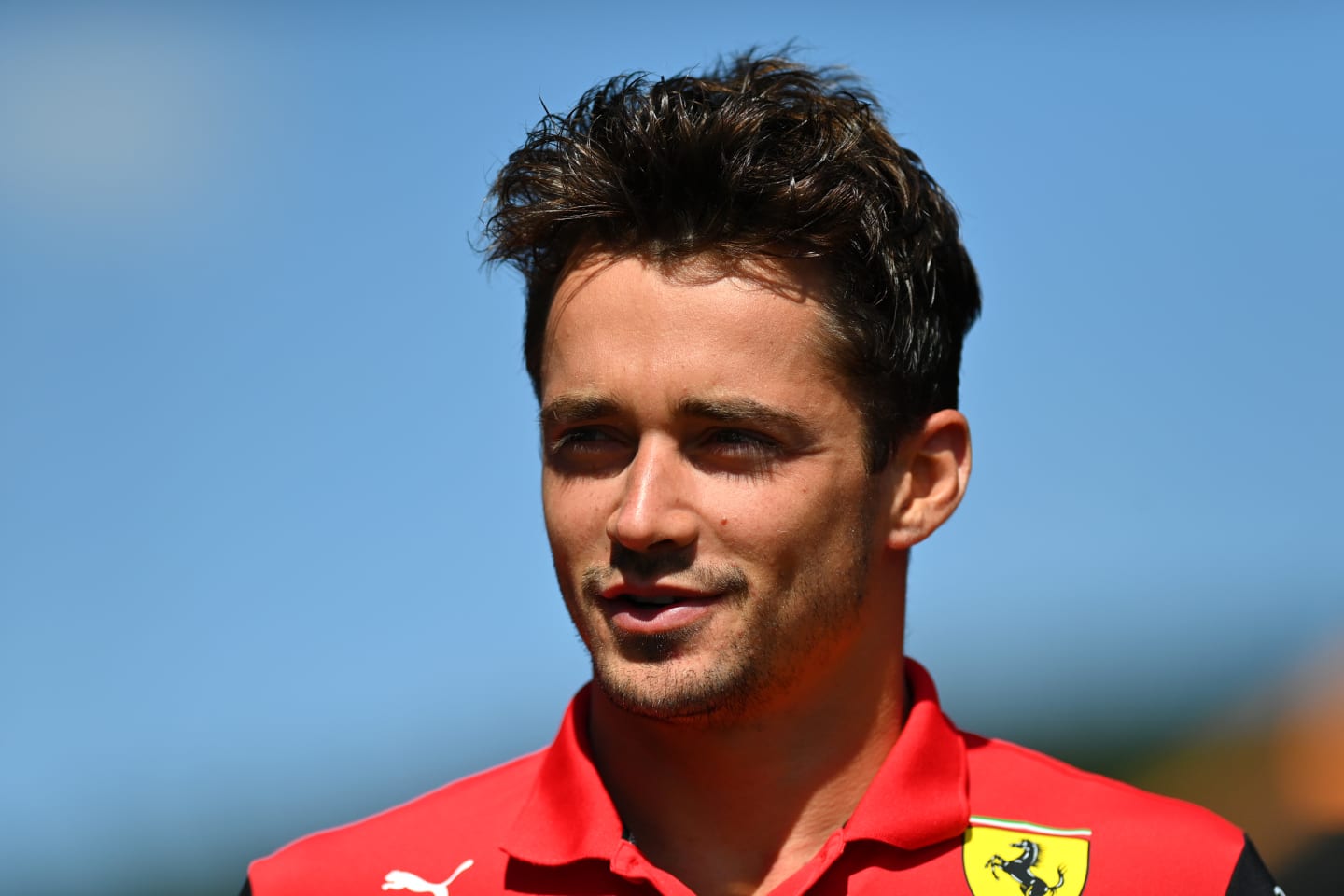 SPA, BELGIUM - AUGUST 25: Charles Leclerc of Monaco and Ferrari walks in the Paddock during