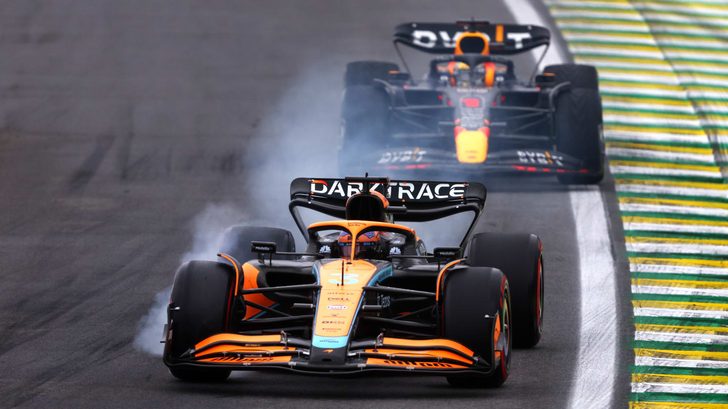 SAO PAULO, BRAZIL - NOVEMBER 11: Daniel Ricciardo of Australia driving the (3) McLaren MCL36 Mercedes locks a wheel under braking in front of Max Verstappen of the Netherlands driving the (1) Oracle Red Bull Racing RB18 during qualifying ahead of the F1 Grand Prix of Brazil at Autodromo Jose Carlos Pace on November 11, 2022 in Sao Paulo, Brazil. (Photo by Bryn Lennon - Formula 1/Formula 1 via Getty Images)