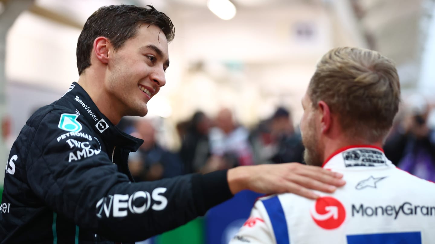 SAO PAULO, BRAZIL - NOVEMBER 11: Third placed qualifier George Russell of Great Britain and Mercedes congratulates Pole position qualifier Kevin Magnussen of Denmark and Haas F1 in parc ferme during qualifying ahead of the F1 Grand Prix of Brazil at Autodromo Jose Carlos Pace on November 11, 2022 in Sao Paulo, Brazil. (Photo by Dan Istitene - Formula 1/Formula 1 via Getty Images)