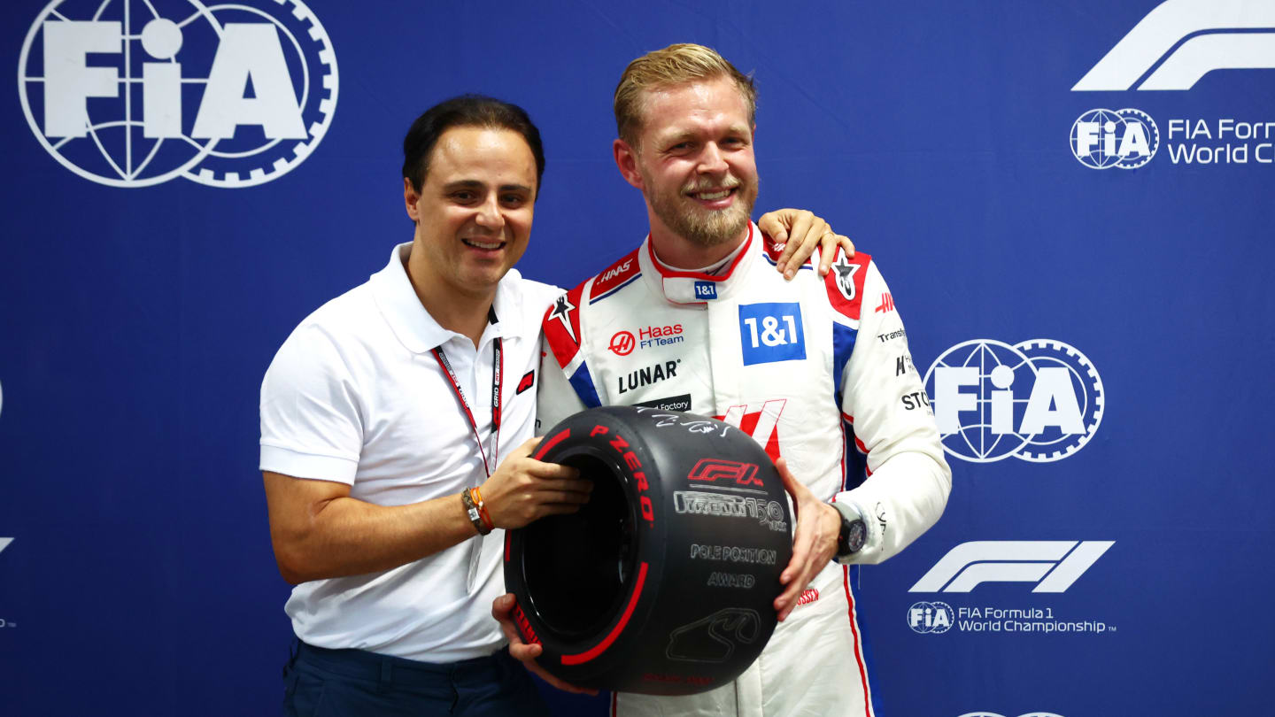 SAO PAULO, BRAZIL - NOVEMBER 11: Pole position qualifier Kevin Magnussen of Denmark and Haas F1 is presented with the Pirelli Pole Position trophy by Felipe Massa during qualifying ahead of the F1 Grand Prix of Brazil at Autodromo Jose Carlos Pace on November 11, 2022 in Sao Paulo, Brazil. (Photo by Dan Istitene - Formula 1/Formula 1 via Getty Images)