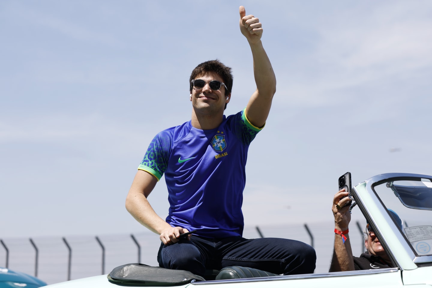 SAO PAULO, BRAZIL - NOVEMBER 13: Lance Stroll of Canada and Aston Martin F1 Team waves to the crowd on the drivers parade prior to the F1 Grand Prix of Brazil at Autodromo Jose Carlos Pace on November 13, 2022 in Sao Paulo, Brazil. (Photo by Jared C. Tilton/Getty Images)