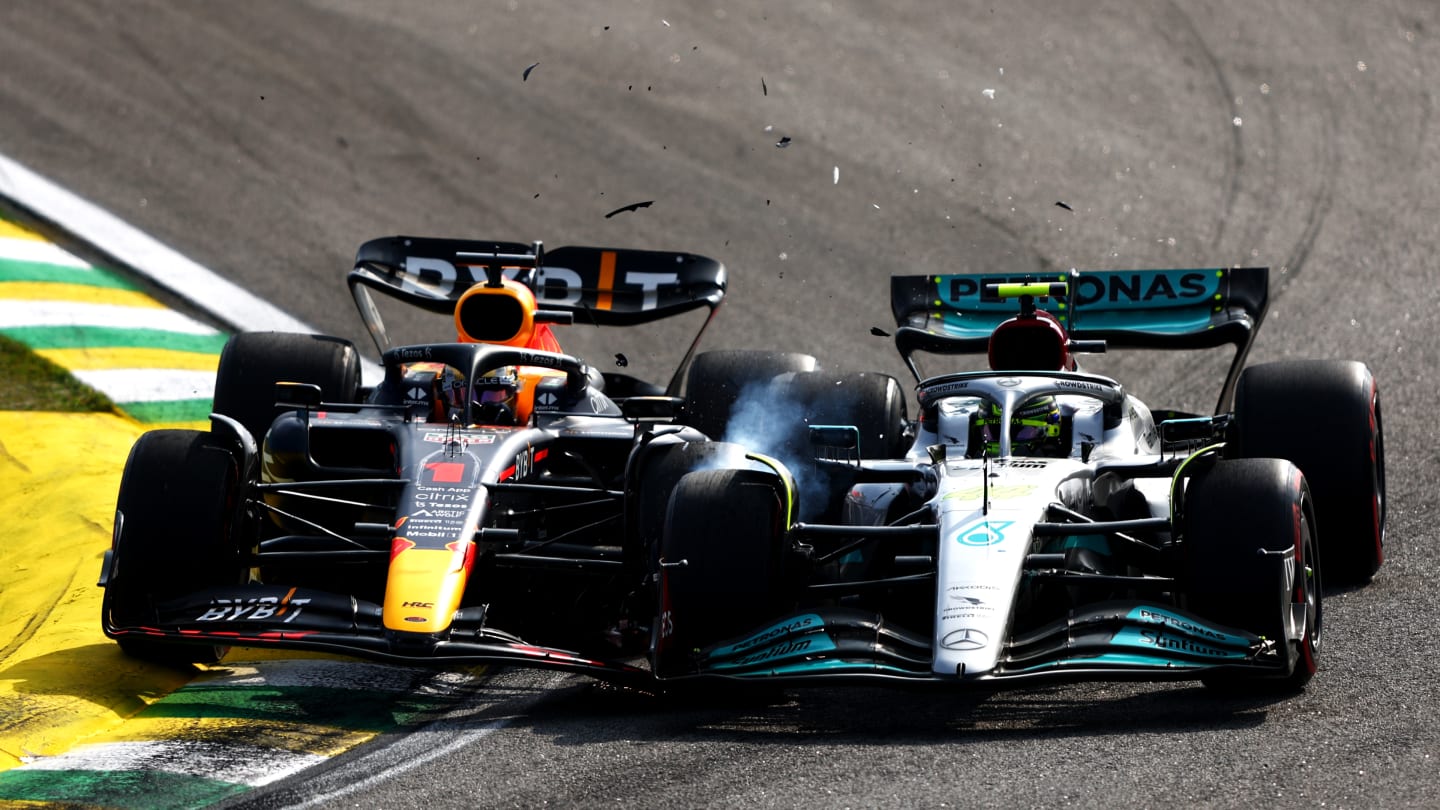 SAO PAULO, BRAZIL - NOVEMBER 13: Max Verstappen of the Netherlands driving the (1) Oracle Red Bull Racing RB18 and Lewis Hamilton of Great Britain driving the (44) Mercedes AMG Petronas F1 Team W13 collide during the F1 Grand Prix of Brazil at Autodromo Jose Carlos Pace on November 13, 2022 in Sao Paulo, Brazil. (Photo by Bryn Lennon - Formula 1/Formula 1 via Getty Images)