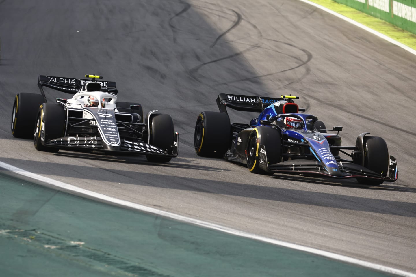SAO PAULO, BRAZIL - NOVEMBER 13: Yuki Tsunoda of Japan driving the (22) Scuderia AlphaTauri AT03 and Nicholas Latifi of Canada driving the (6) Williams FW44 Mercedes battle for track position during the F1 Grand Prix of Brazil at Autodromo Jose Carlos Pace on November 13, 2022 in Sao Paulo, Brazil. (Photo by Chris Graythen/Getty Images)