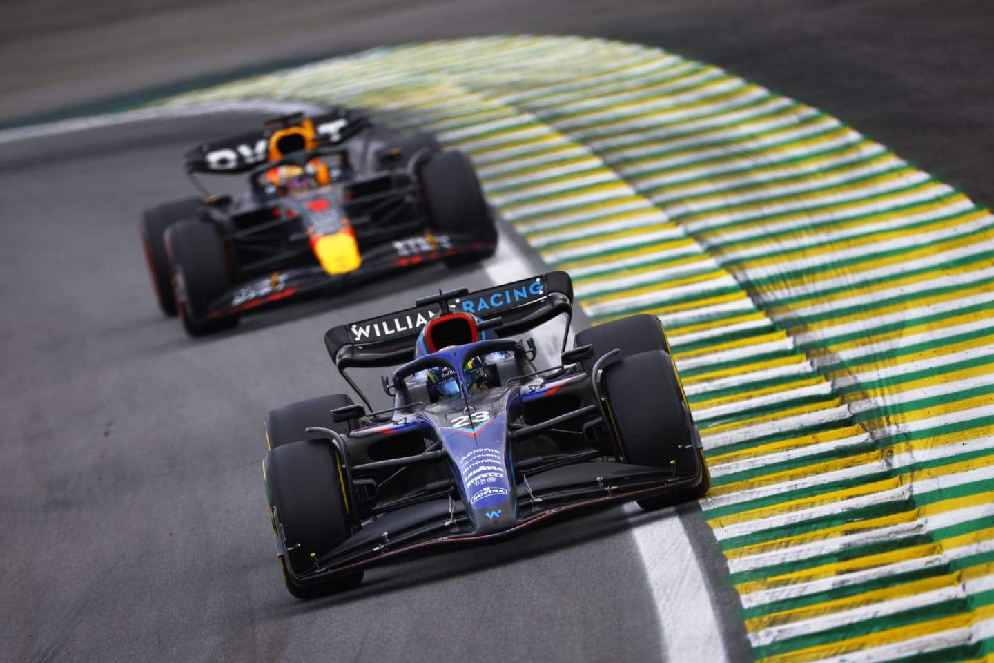 SAO PAULO, BRAZIL - NOVEMBER 13: Alexander Albon of Thailand driving the (23) Williams FW44 Mercedes leads Max Verstappen of the Netherlands driving the (1) Oracle Red Bull Racing RB18 during the F1 Grand Prix of Brazil at Autodromo Jose Carlos Pace on November 13, 2022 in Sao Paulo, Brazil. (Photo by Jared C. Tilton/Getty Images)