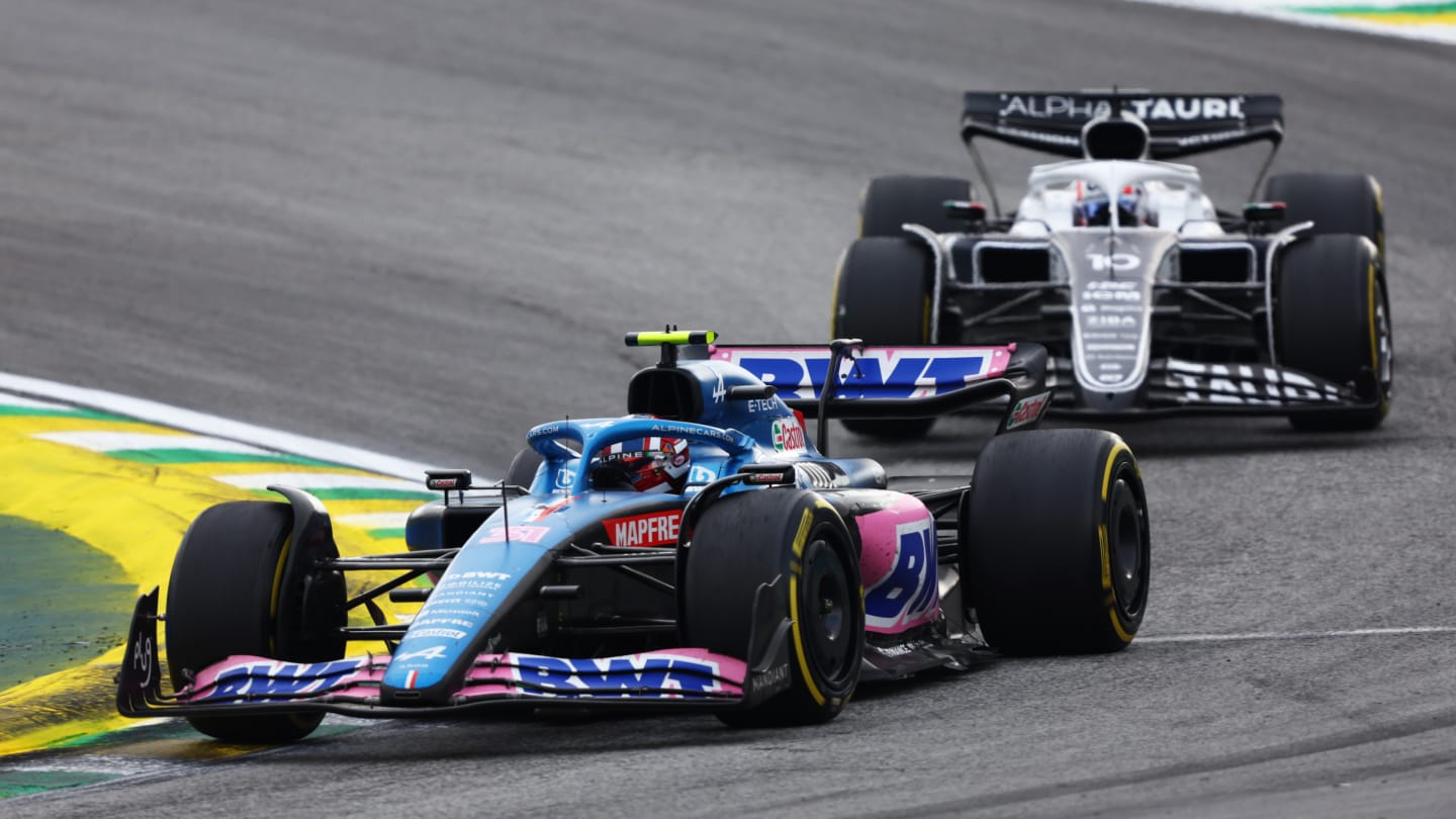 SAO PAULO, BRAZIL - NOVEMBER 13: Esteban Ocon of France driving the (31) Alpine F1 A522 Renault leads Pierre Gasly of France driving the (10) Scuderia AlphaTauri AT03 during the F1 Grand Prix of Brazil at Autodromo Jose Carlos Pace on November 13, 2022 in Sao Paulo, Brazil. (Photo by Bryn Lennon - Formula 1/Formula 1 via Getty Images)