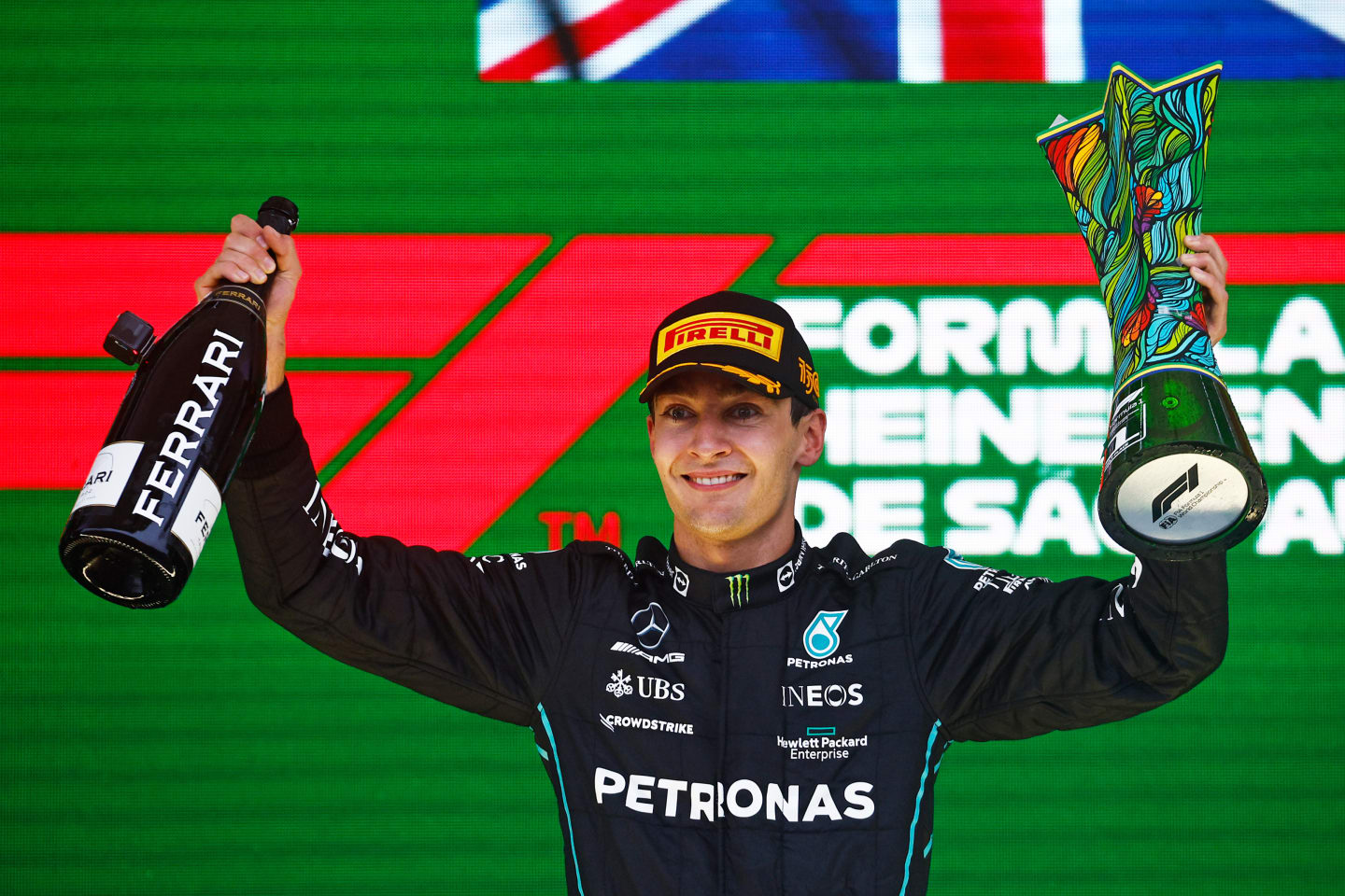 SAO PAULO, BRAZIL - NOVEMBER 13: Race winner George Russell of Great Britain and Mercedes celebrates on the podium during the F1 Grand Prix of Brazil at Autodromo Jose Carlos Pace on November 13, 2022 in Sao Paulo, Brazil. (Photo by Chris Graythen/Getty Images)