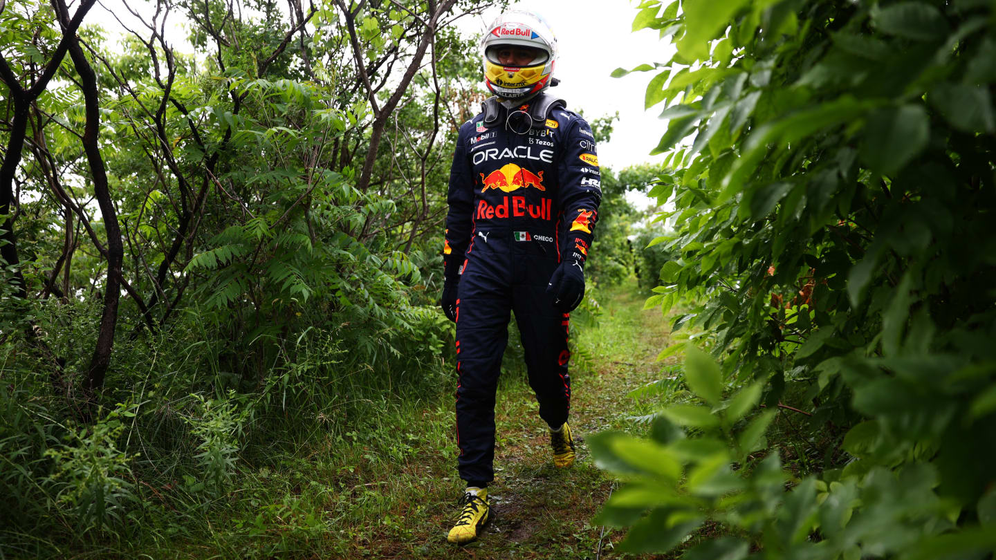 MONTREAL, QUEBEC - JUNE 18: Sergio Perez of Mexico and Oracle Red Bull Racing walks back to the paddock after crashing during qualifying ahead of the F1 Grand Prix of Canada at Circuit Gilles Villeneuve on June 18, 2022 in Montreal, Quebec. (Photo by Dan Istitene - Formula 1/Formula 1 via Getty Images)