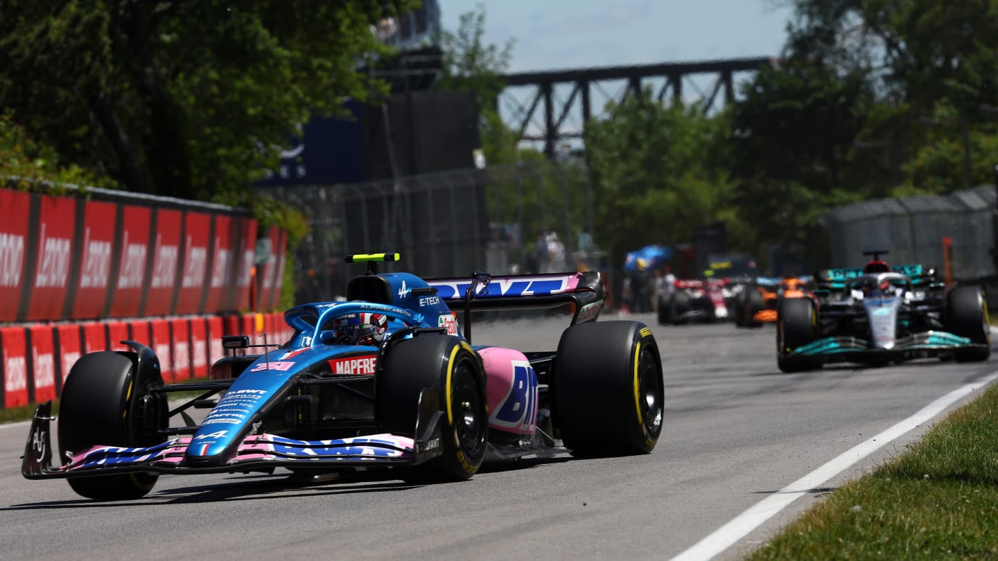 MONTREAL, QUEBEC - JUNE 19: Esteban Ocon of France driving the (31) Alpine F1 A522 Renault leads George Russell of Great Britain driving the (63) Mercedes AMG Petronas F1 Team W13 during the F1 Grand Prix of Canada at Circuit Gilles Villeneuve on June 19, 2022 in Montreal, Quebec. (Photo by Lars Baron - Formula 1/Formula 1 via Getty Images)