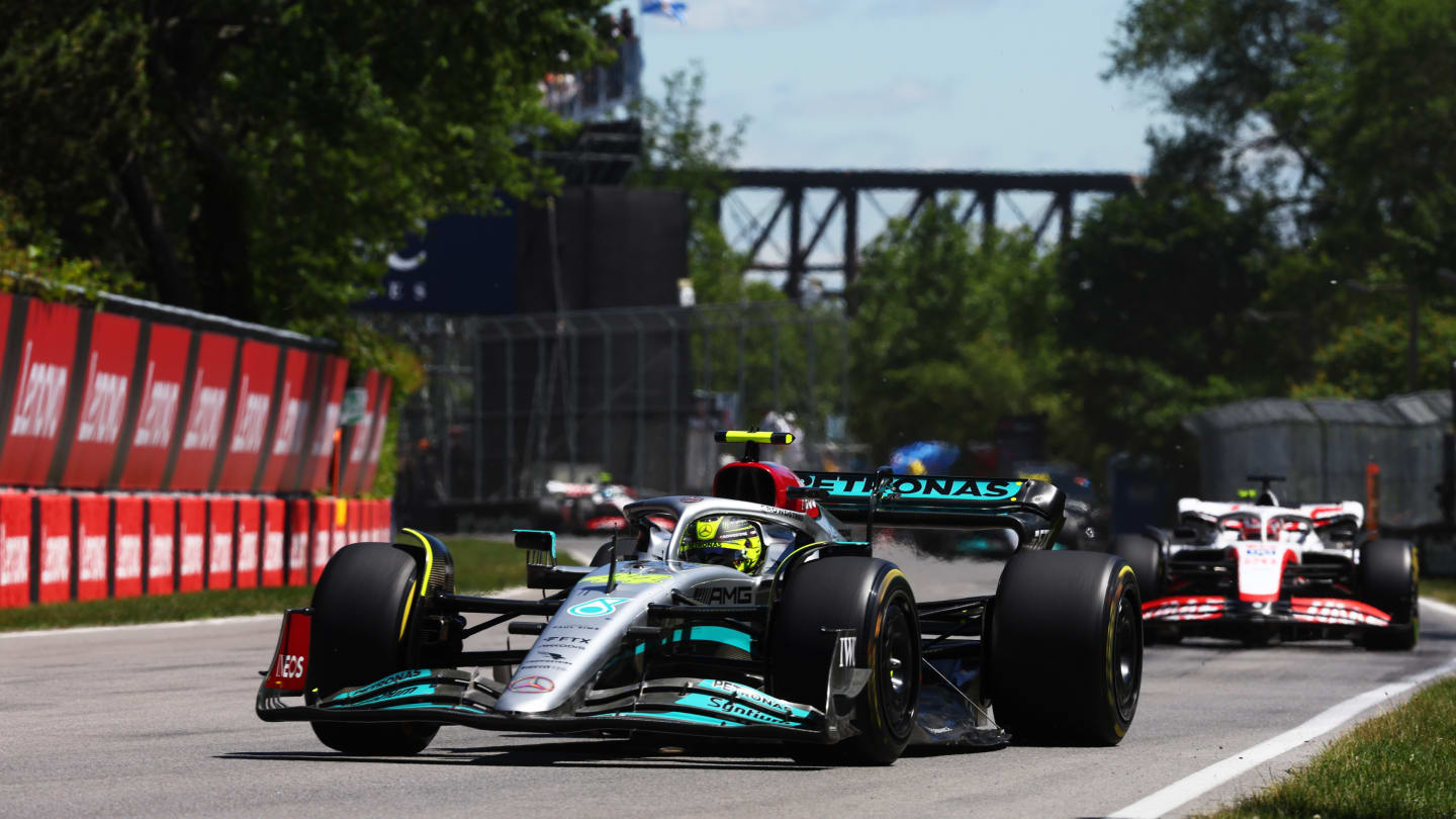 MONTREAL, QUEBEC - JUNE 19: Lewis Hamilton of Great Britain driving the (44) Mercedes AMG Petronas F1 Team W13 leads Kevin Magnussen of Denmark driving the (20) Haas F1 VF-22 Ferrari during the F1 Grand Prix of Canada at Circuit Gilles Villeneuve on June 19, 2022 in Montreal, Quebec. (Photo by Lars Baron - Formula 1/Formula 1 via Getty Images)