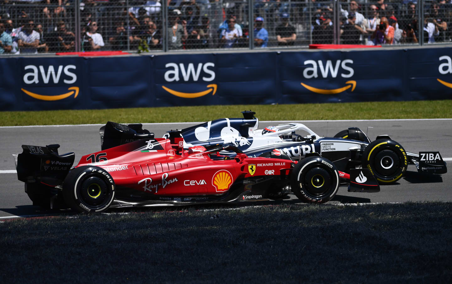 MONTREAL, QUEBEC - JUNE 19: Pierre Gasly of France driving the (10) Scuderia AlphaTauri AT03 leads Charles Leclerc of Monaco driving the (16) Ferrari F1-75 during the F1 Grand Prix of Canada at Circuit Gilles Villeneuve on June 19, 2022 in Montreal, Quebec. (Photo by Dan Mullan/Getty Images)