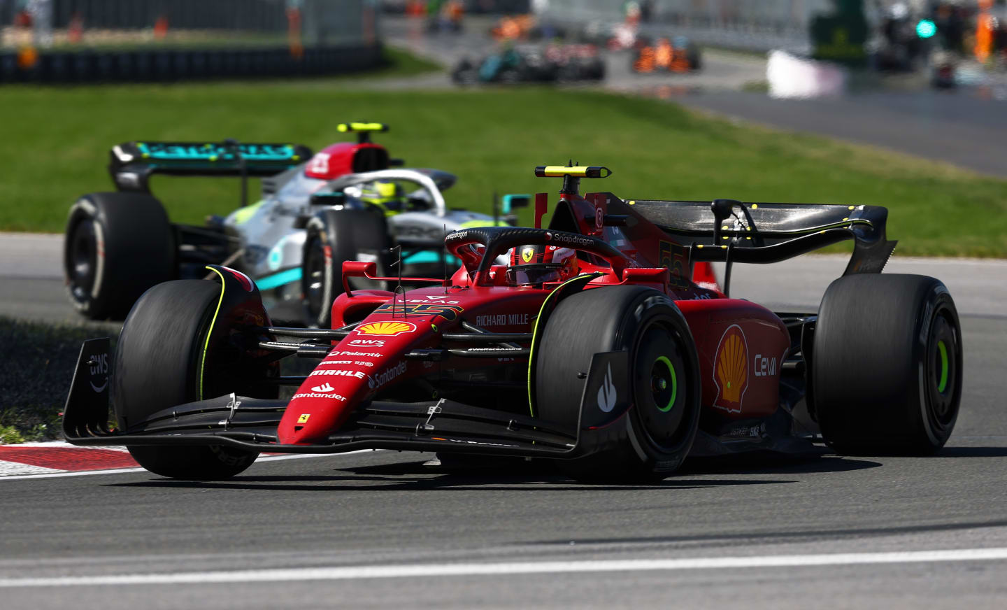 MONTREAL, QUEBEC - JUNE 19: Carlos Sainz of Spain driving (55) the Ferrari F1-75 leads Lewis Hamilton of Great Britain driving the (44) Mercedes AMG Petronas F1 Team W13 during the F1 Grand Prix of Canada at Circuit Gilles Villeneuve on June 19, 2022 in Montreal, Quebec. (Photo by Lars Baron - Formula 1/Formula 1 via Getty Images)