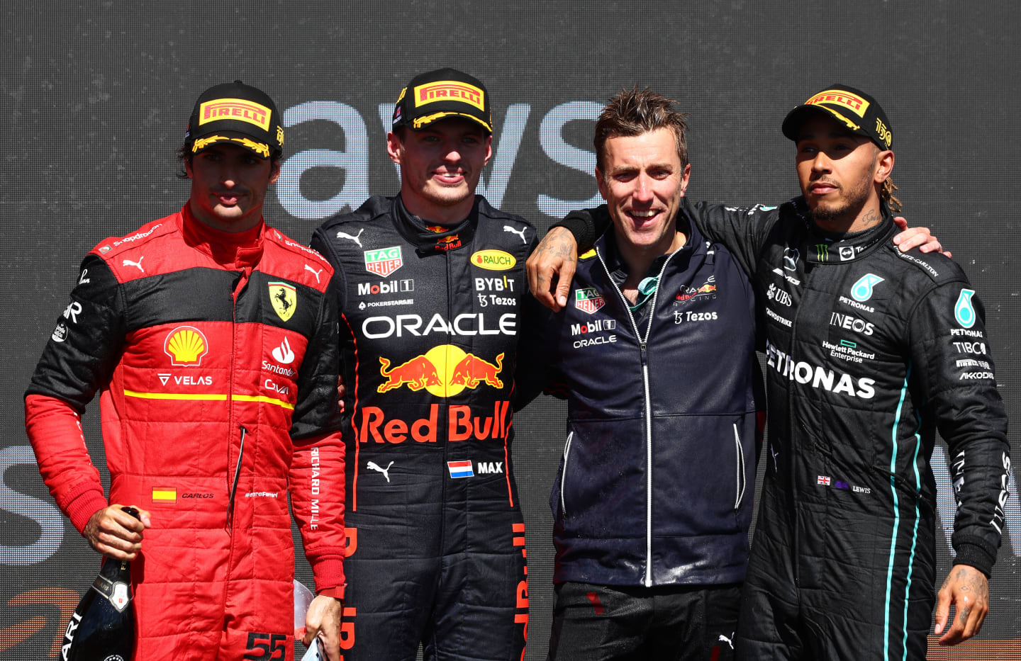 MONTREAL, QUEBEC - JUNE 19: Race winner Max Verstappen of the Netherlands and Oracle Red Bull Racing (second from left), Second placed Carlos Sainz of Spain and Ferrari (L), Third placed Lewis Hamilton of Great Britain and Mercedes (R) and Ben Gordon-Smith of Red Bull Racing (second from right) celebrate on the podium during the F1 Grand Prix of Canada at Circuit Gilles Villeneuve on June 19, 2022 in Montreal, Quebec. (Photo by Clive Rose/Getty Images)