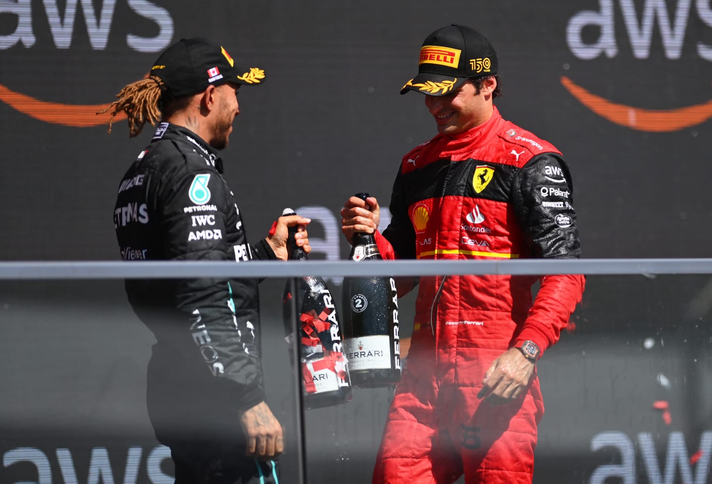 MONTREAL, QUEBEC - JUNE 19: Second placed Carlos Sainz of Spain and Ferrari and Third placed Lewis Hamilton of Great Britain and Mercedes celebrate on the podium during the F1 Grand Prix of Canada at Circuit Gilles Villeneuve on June 19, 2022 in Montreal, Quebec. (Photo by Dan Mullan/Getty Images)