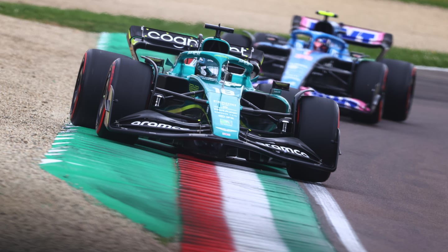 IMOLA, ITALY - APRIL 23: Lance Stroll of Canada driving the (18) Aston Martin AMR22 Mercedes leads Esteban Ocon of France driving the (31) Alpine F1 A522 Renault during Sprint ahead of the F1 Grand Prix of Emilia Romagna at Autodromo Enzo e Dino Ferrari on April 23, 2022 in Imola, Italy. (Photo by Dan Istitene - Formula 1/Formula 1 via Getty Images)