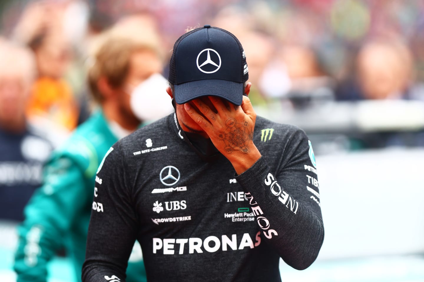 IMOLA, ITALY - APRIL 24: Lewis Hamilton of Great Britain and Mercedes wipes his face on the grid