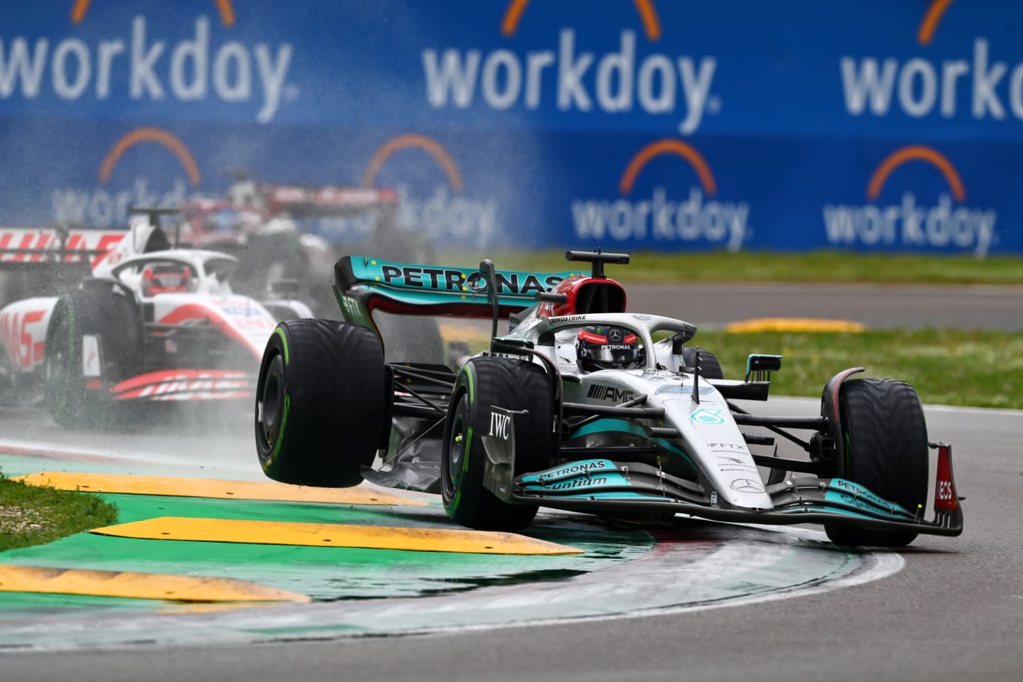 IMOLA, ITALY - APRIL 24: George Russell of Great Britain driving the (63) Mercedes AMG Petronas F1 Team W13 runs wide as he defends track position from Kevin Magnussen of Denmark driving the (20) Haas F1 VF-22 Ferrari during the F1 Grand Prix of Emilia Romagna at Autodromo Enzo e Dino Ferrari on April 24, 2022 in Imola, Italy. (Photo by Dan Mullan/Getty Images)