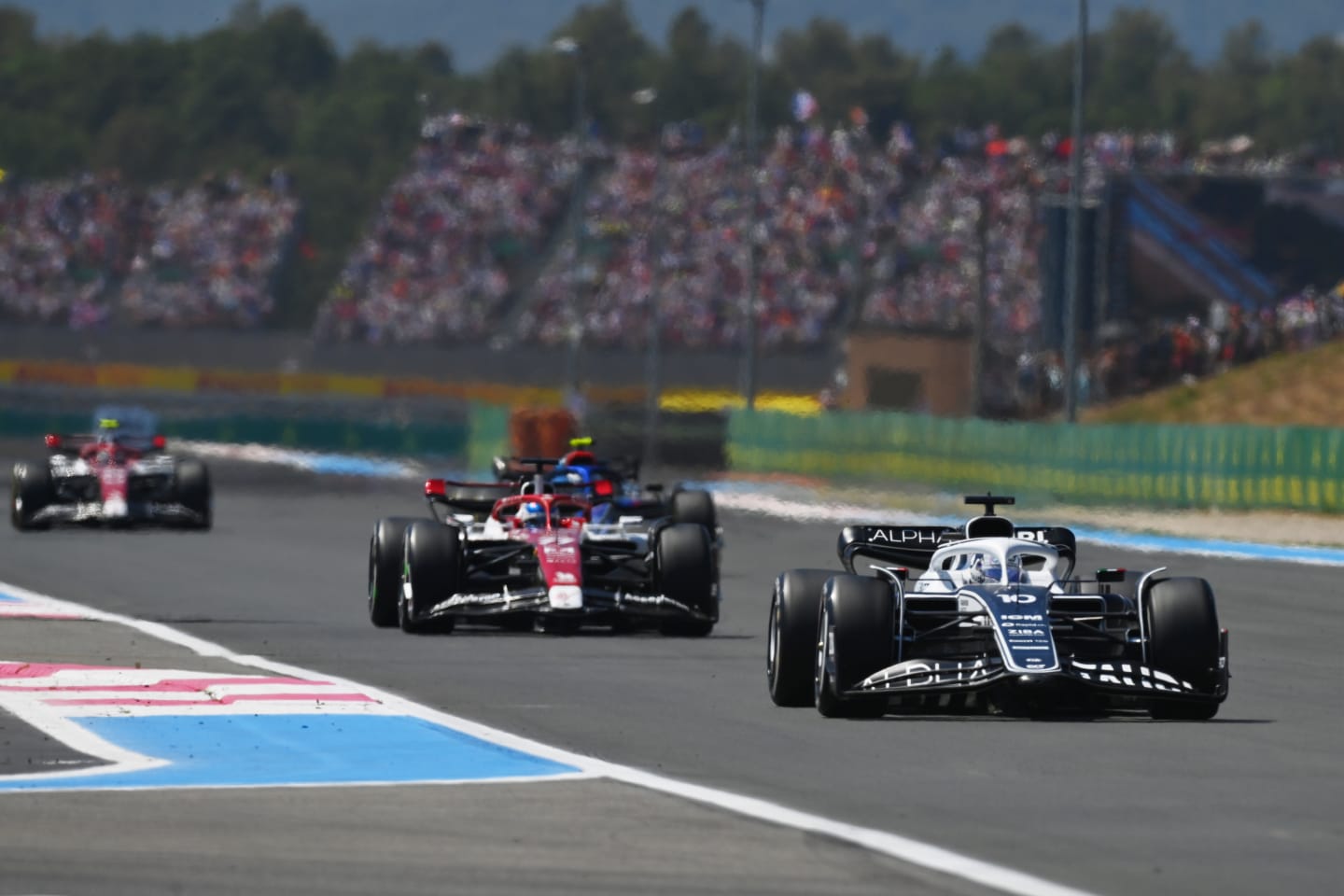 LE CASTELLET, FRANCE - JULY 24: Pierre Gasly of France driving the (10) Scuderia AlphaTauri AT03 leads Valtteri Bottas of Finland driving the (77) Alfa Romeo F1 C42 Ferrari during the F1 Grand Prix of France at Circuit Paul Ricard on July 24, 2022 in Le Castellet, France. (Photo by Dan Mullan/Getty Images)