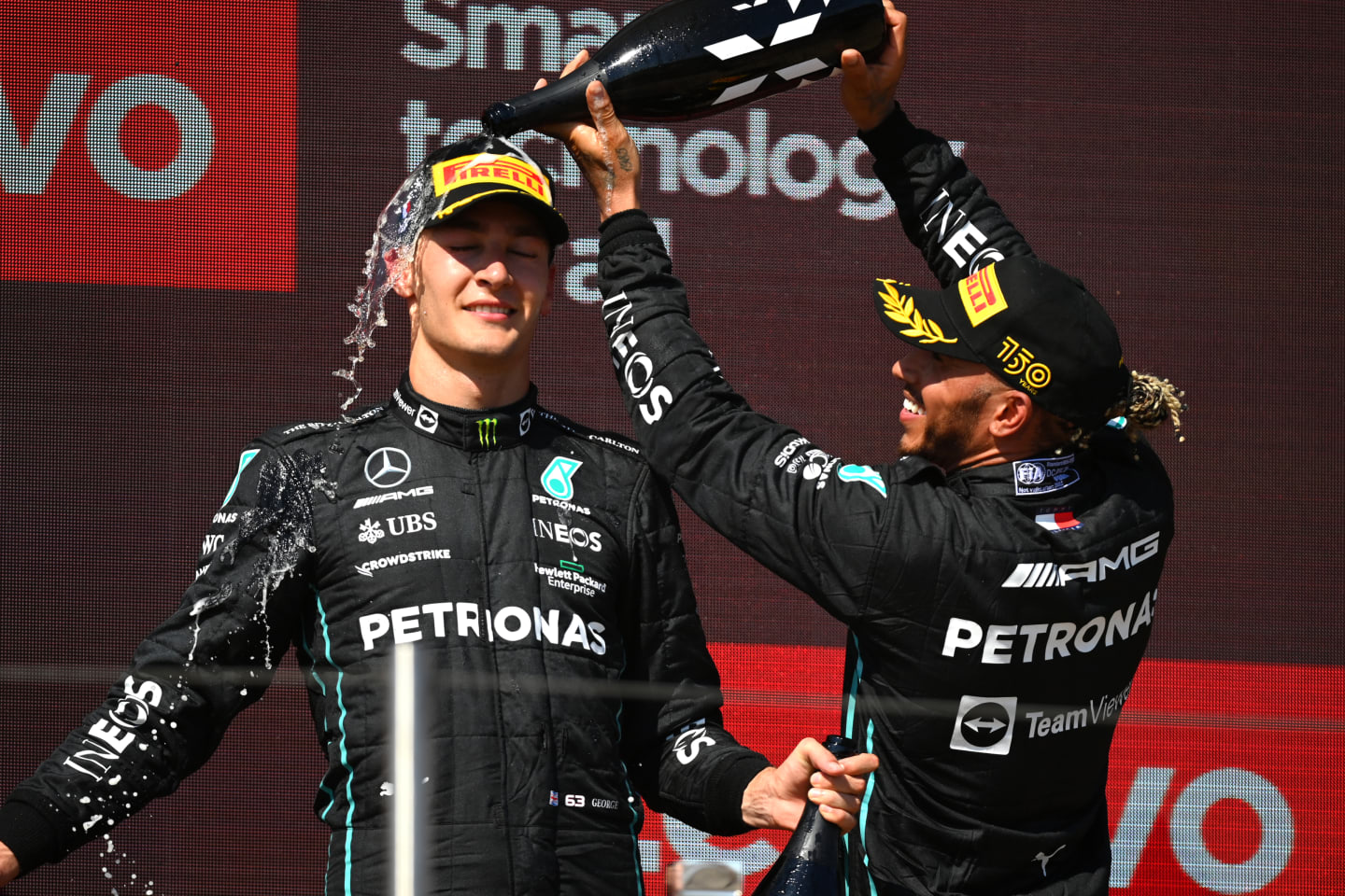 LE CASTELLET, FRANCE - JULY 24: Second placed Lewis Hamilton of Great Britain and Mercedes and Third placed George Russell of Great Britain and Mercedes celebrate on the podium during the F1 Grand Prix of France at Circuit Paul Ricard on July 24, 2022 in Le Castellet, France. (Photo by Dan Mullan/Getty Images)