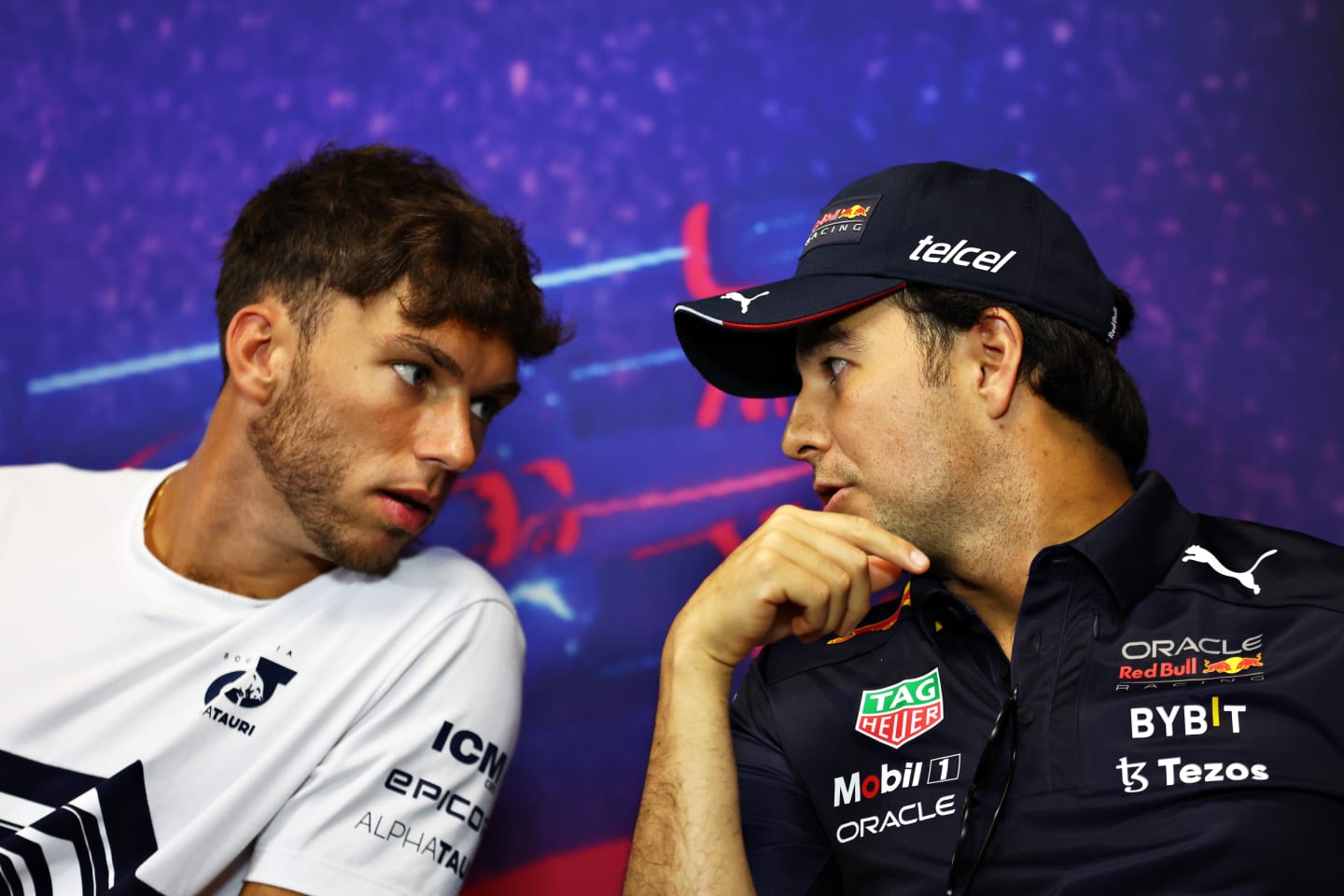LE CASTELLET, FRANCE - JULY 21: Pierre Gasly of France and Scuderia AlphaTauri and Sergio Perez of Mexico and Oracle Red Bull Racing talk in the Drivers Press Conference during previews ahead of the F1 Grand Prix of France at Circuit Paul Ricard on July 21, 2022 in Le Castellet, France. (Photo by Bryn Lennon/Getty Images)