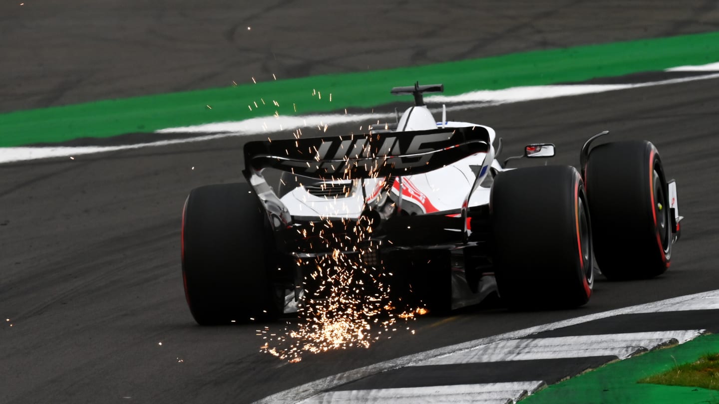 NORTHAMPTON, ENGLAND - JULY 02: Sparks fly behind Kevin Magnussen of Denmark driving the (20) Haas F1 VF-22 Ferrari on track during final practice ahead of the F1 Grand Prix of Great Britain at Silverstone on July 02, 2022 in Northampton, England. (Photo by Dan Mullan - Formula 1/Formula 1 via Getty Images)