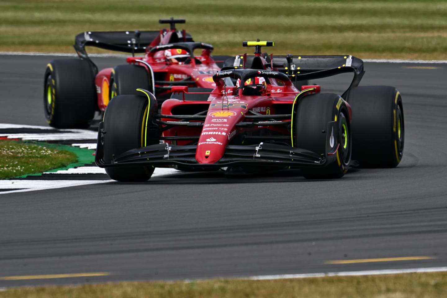 NORTHAMPTON, ENGLAND - JULY 03: Carlos Sainz of Spain driving (55) the Ferrari F1-75 leads Charles