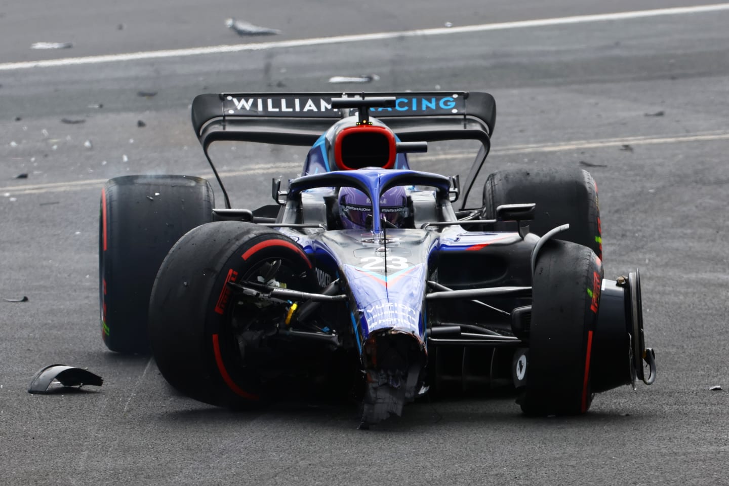 NORTHAMPTON, ENGLAND - JULY 03:  Alexander Albon of Thailand driving the (23) Williams FW44 Mercedes runs off the track after a crash at the start during the F1 Grand Prix of Great Britain at Silverstone on July 03, 2022 in Northampton, England. (Photo by Mark Thompson/Getty Images)