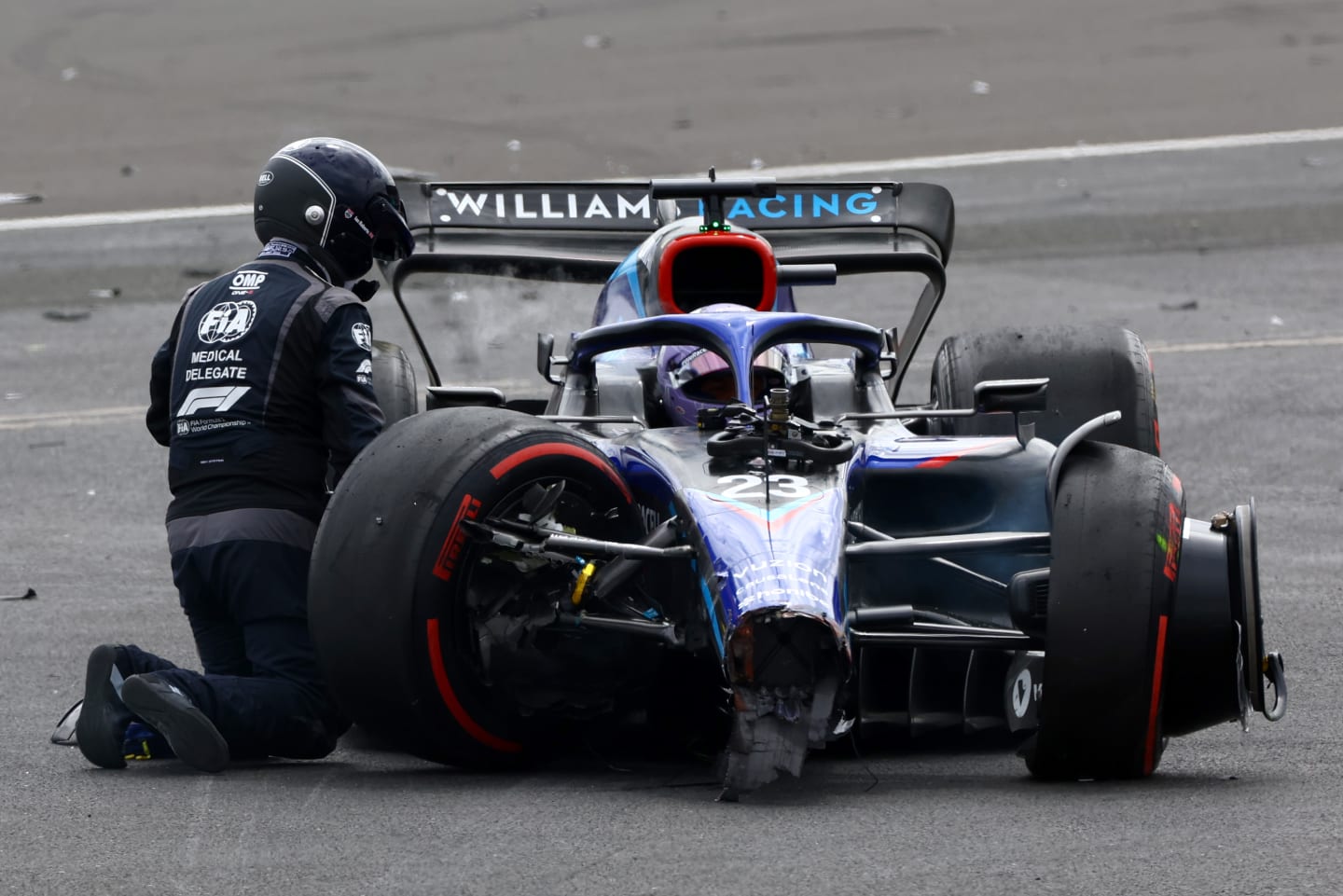 NORTHAMPTON, ENGLAND - JULY 03:  An FIA Medical Delegate checks on Alexander Albon of Thailand