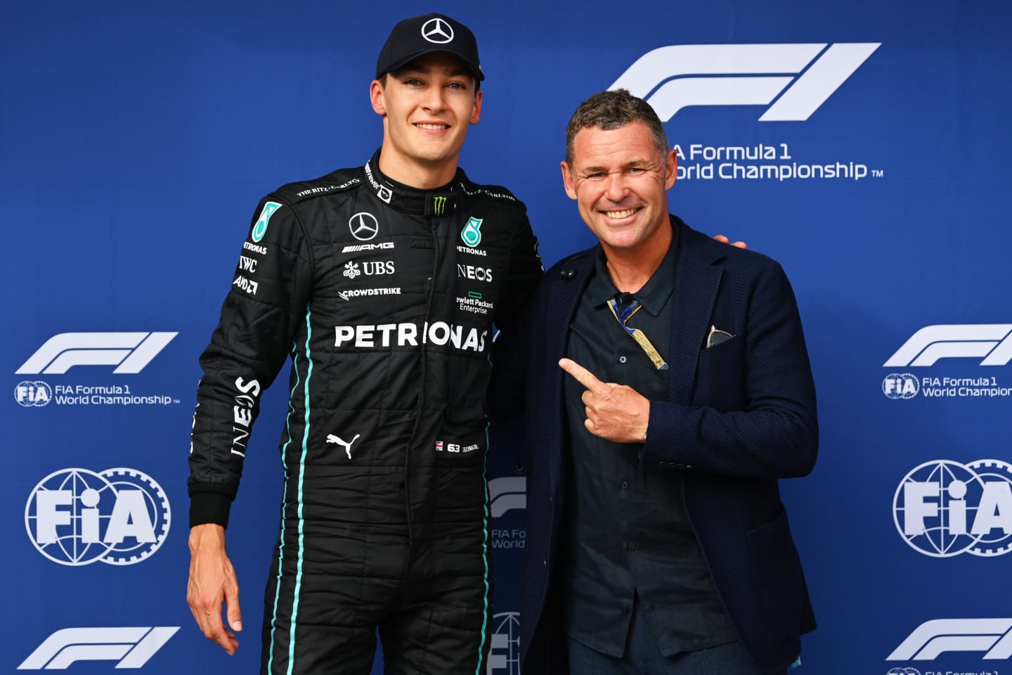BUDAPEST, HUNGARY - JULY 30: Pole position qualifier George Russell of Great Britain and Mercedes is presented with the Pirelli Pole Position trophy by Tom Kristensen during qualifying ahead of the F1 Grand Prix of Hungary at Hungaroring on July 30, 2022 in Budapest, Hungary. (Photo by Dan Mullan/Getty Images)