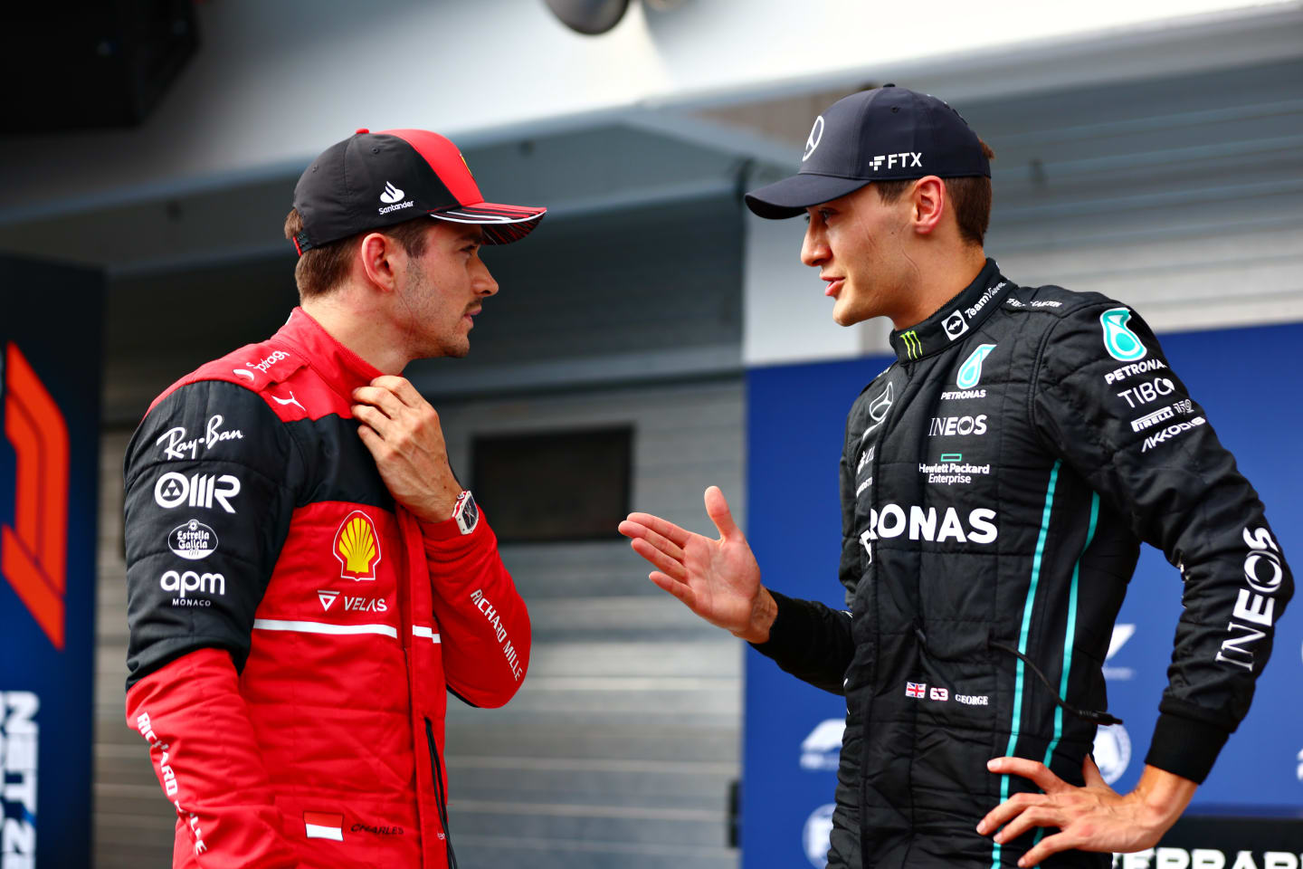 BUDAPEST, HUNGARY - JULY 30: Pole position qualifier George Russell of Great Britain and Mercedes talks with Third placed qualifier Charles Leclerc of Monaco and Ferrari in parc ferme during qualifying ahead of the F1 Grand Prix of Hungary at Hungaroring on July 30, 2022 in Budapest, Hungary. (Photo by Dan Istitene - Formula 1/Formula 1 via Getty Images)