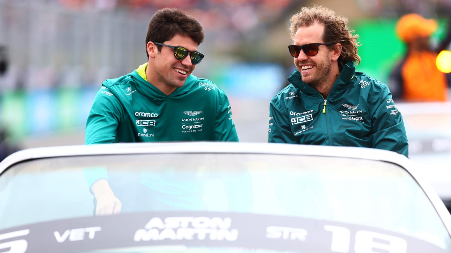 BUDAPEST, HUNGARY - JULY 31: Sebastian Vettel of Germany and Aston Martin F1 Team and Lance Stroll of Canada and Aston Martin F1 Team look on from the drivers parade ahead of the F1 Grand Prix of Hungary at Hungaroring on July 31, 2022 in Budapest, Hungary. (Photo by Mark Thompson/Getty Images)