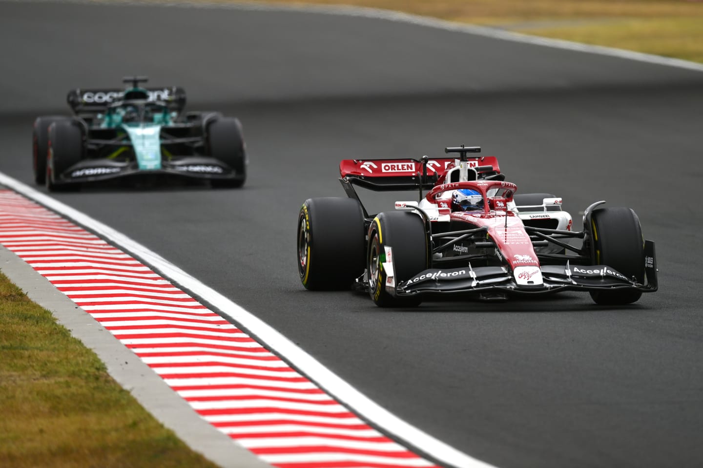BUDAPEST, HUNGARY - JULY 31: Valtteri Bottas of Finland driving the (77) Alfa Romeo F1 C42 Ferrari leads Lance Stroll of Canada driving the (18) Aston Martin AMR22 Mercedes during the F1 Grand Prix of Hungary at Hungaroring on July 31, 2022 in Budapest, Hungary. (Photo by Dan Mullan/Getty Images)