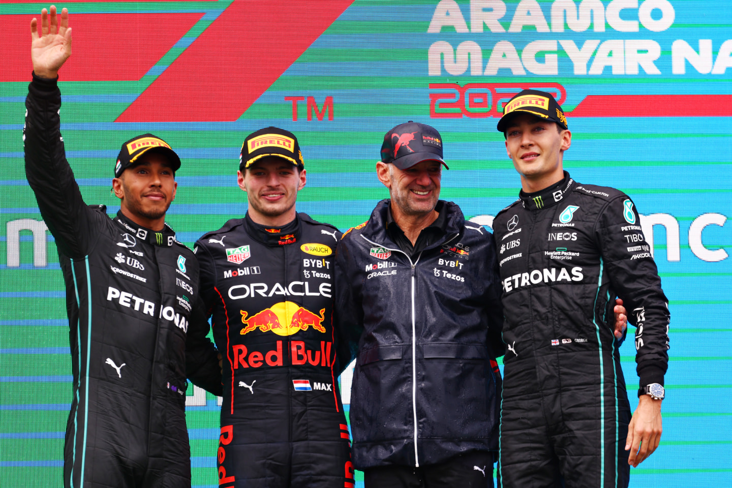 BUDAPEST, HUNGARY - JULY 31: Race winner Max Verstappen of the Netherlands and Oracle Red Bull Racing (second from left), Second placed Lewis Hamilton of Great Britain and Mercedes (L), Third placed George Russell of Great Britain and Mercedes (R) and Adrian Newey, the Chief Technical Officer of Red Bull Racing (second from right) celebrate on the podium during the F1 Grand Prix of Hungary at Hungaroring on July 31, 2022 in Budapest, Hungary. (Photo by Bryn Lennon - Formula 1/Formula 1 via Getty Images)