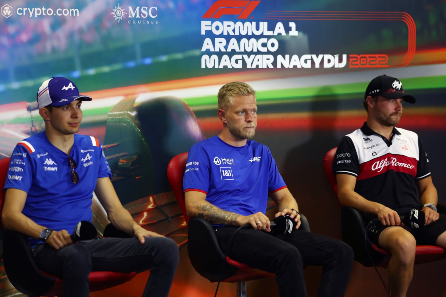 BUDAPEST, HUNGARY - JULY 28: Esteban Ocon of France and Alpine F1, Kevin Magnussen of Denmark and Haas F1 and Valtteri Bottas of Finland and Alfa Romeo F1 look on in the Drivers Press Conference during previews ahead of the F1 Grand Prix of Hungary at Hungaroring on July 28, 2022 in Budapest, Hungary. (Photo by Bryn Lennon/Getty Images)