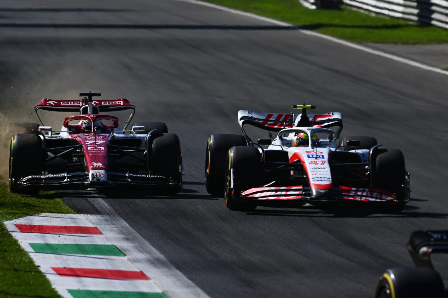MONZA, ITALY - SEPTEMBER 11: Valtteri Bottas of Finland driving the (77) Alfa Romeo F1 C42 Ferrari runs wide as he and Mick Schumacher of Germany and Haas F1 battle for track position during the F1 Grand Prix of Italy at Autodromo Nazionale Monza on September 11, 2022 in Monza, Italy. (Photo by Clive Mason/Getty Images)