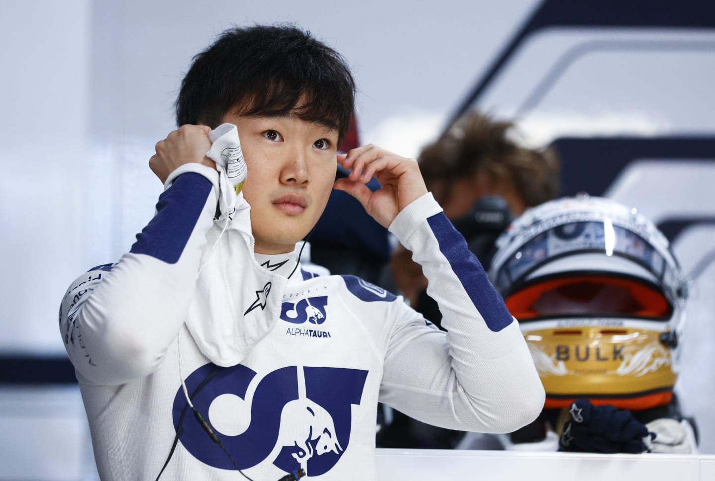 SUZUKA, JAPAN - OCTOBER 07: Yuki Tsunoda of Japan and Scuderia AlphaTauri prepares to drive in the garage during practice ahead of the F1 Grand Prix of Japan at Suzuka International Racing Course on October 07, 2022 in Suzuka, Japan. (Photo by Clive Rose/Getty Images)
